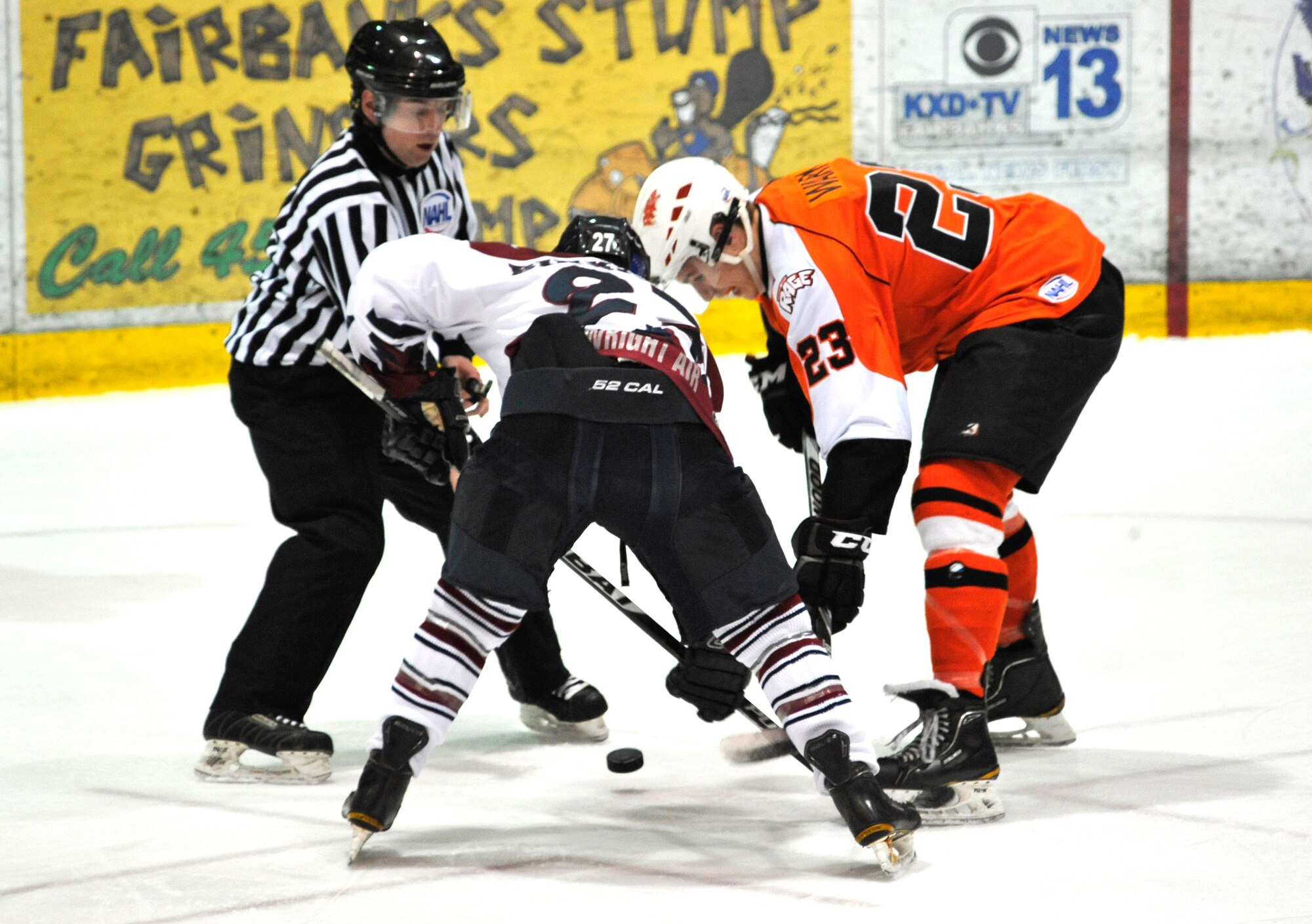 Fairbanks Ice Dogs forward Max Birkinbine battles for the puck during a face off against a Dawson Creek Rage forward during a Military Appreciation game at Big Dipper Arena, March 30, 2012, Fairbanks, Alaska.  The Ice Dogs won 6-5.  (U.S. Air Force photo/Staff Sgt. Miguel Lara III)