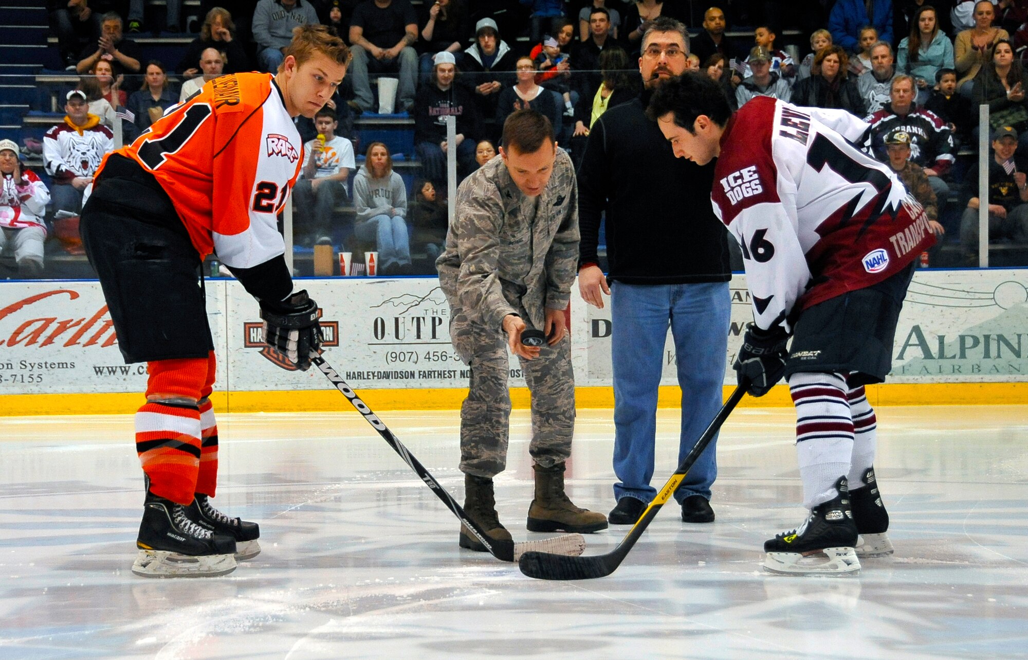 U.S. Air Force Col. Lynn Scheel, 354th Fighter Wing vice commander, drops the ceremonial puck to kick-off Military Appreciation Weekend at the Big Dipper Arena, March 30, 2012, Fairbanks, Alaska.  The Fairbanks Ice Dogs defeated Dawson Creek Rage 6-with a game-winning goal in the final 19 seconds of the game.  (U.S. Air Force photo/Staff Sgt. Miguel Lara III)