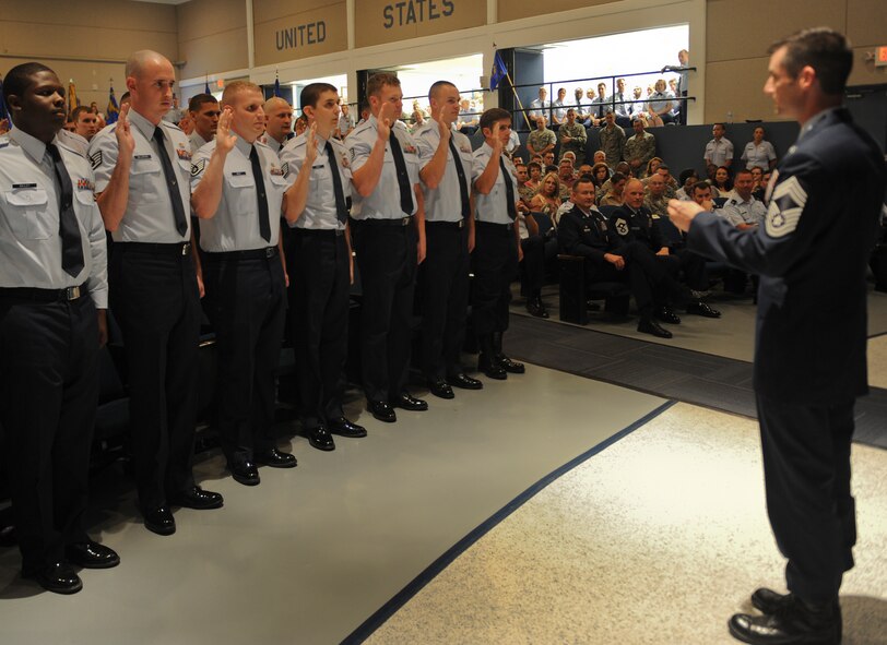 U.S. Air Force Chief Master Sgt. Matthew Wells, 347th Rescue Group, administers the oath to the noncommissioned officer inductees at Moody Air Force Base, Ga. April 2, 2012. Approximately 50 Airmen were promoted between the ranks of staff sergeant through senior master sergeant during Team Moody’s monthly promotion ceremony. (U.S.  Air Force photo by Airman 1st Class Doug Ellis/Released)