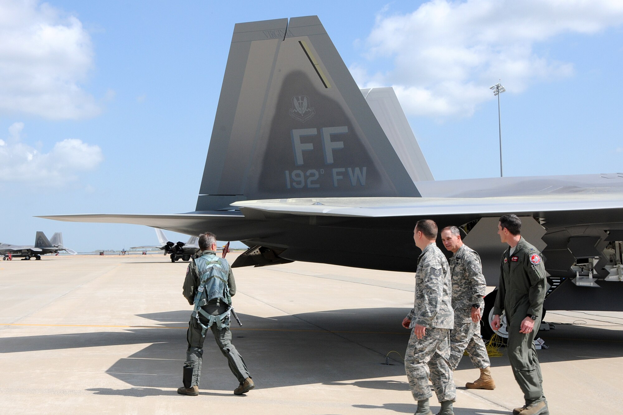 Tech. Sgt. Harrison B. Southworth II (second from left), a 192nd Fighter Wing F-22 Raptor crew chief, speaks with Maj. Gen. Daniel E. Long, the Adjutant General to the Virginia National Guard, about the new 192nd FW flagship at Langley Air Force Base, Va., March 22, 2012. The aircraft bears tail number 09-0192, which shares the namesake of the Virginia Air National Guard unit. (National Guard Photo by Master Sgt. Carlos J. Claudio/Released)