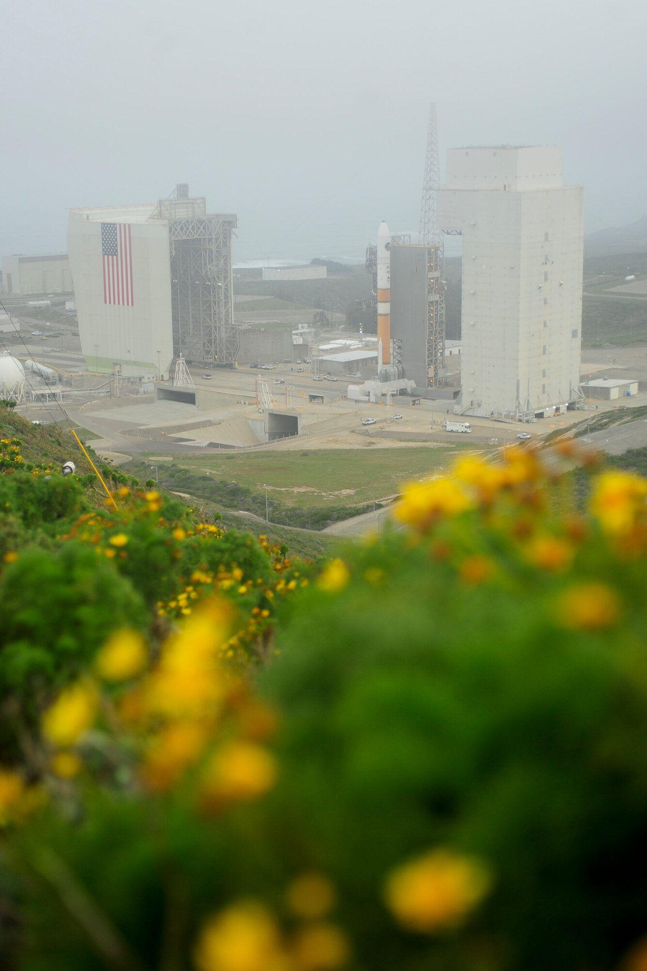 VANDENBERG AIR FORCE BASE, Calif. -- The mobile service tower rolls back from the United Launch Alliance Delta IV Medium+ (5,2) rocket on Space Launch Complex 6 here Tuesday, April 3, 2012. This is the Department of Defense?s first-ever launch of a Delta IV configured with a 5-meter payload fairing and two solid rocket motors. (U.S. Air Force photo/Staff Sgt. Andrew Satran)