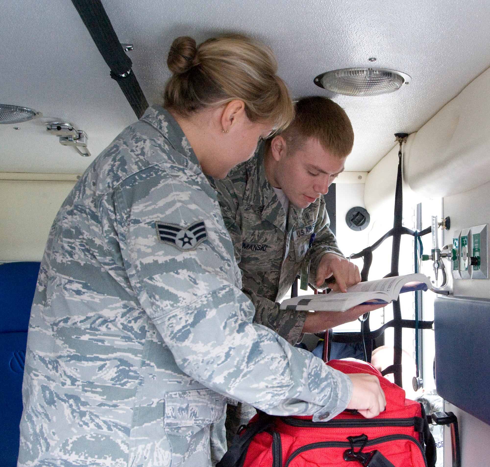 Senior Airman Miranda Bryant, left, and Senior Airman Daniel Shimanski, members of the Ambulance Response Team with the 436th Medical Operations Squadron, go through their gear after responding to a call April, 2, 2012, at Dover Air Force Base, Del. The ART takes time to check their gear every day to ensure everything meets specifications. (U.S. Air Force photo by Senior Airman Matthew Hubby)