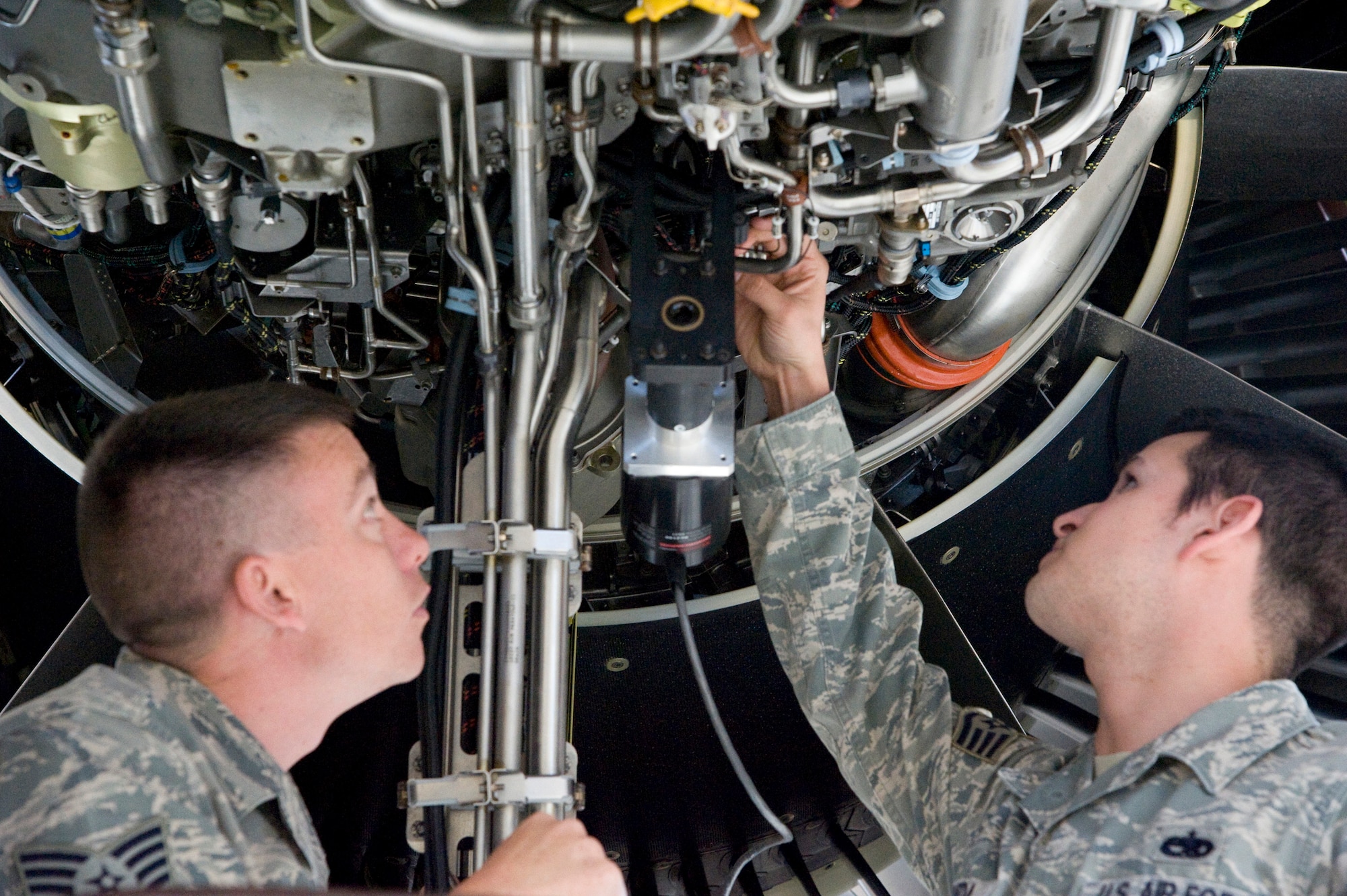 Tech. Sgt. James Shropshire, left, observes Staff Sgt. Jerry Esqueda as he inspects a C-5M Super Galaxy training engine April 2, 2012, at Dover Air Force Base, Del. This training will help establish the future maintenance protocols for the C-5M. Shropshire is a propulsion instructor with the 373rd Training Squadron Detachment 3 from Sheppard Air Force Base, Texas, and Esqueda is an aerospace propulsion specialist with the 721st Aircraft Maintenance Squadron, at Ramstein Air Base, Germany. (U.S. Air Force photo by Senior Airman Matthew Hubby)
