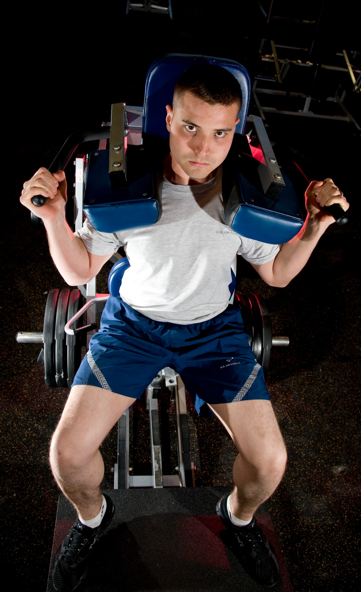 U.S. Air Force Airman 1st Class Joseph Martinelli, 757th  Aircraft Maintenance Squadron A-10 aerospace electrical and environmental system apprentice, works out using the V-Squat machine at the brand new Warrior Fitness Center April 2, 2012, at Nellis Air Force Base, Nev. The 110,000 square foot facility officially opens its doors April 10th. (U.S. Air Force photo by Master Sgt. Jason W. Edwards)
