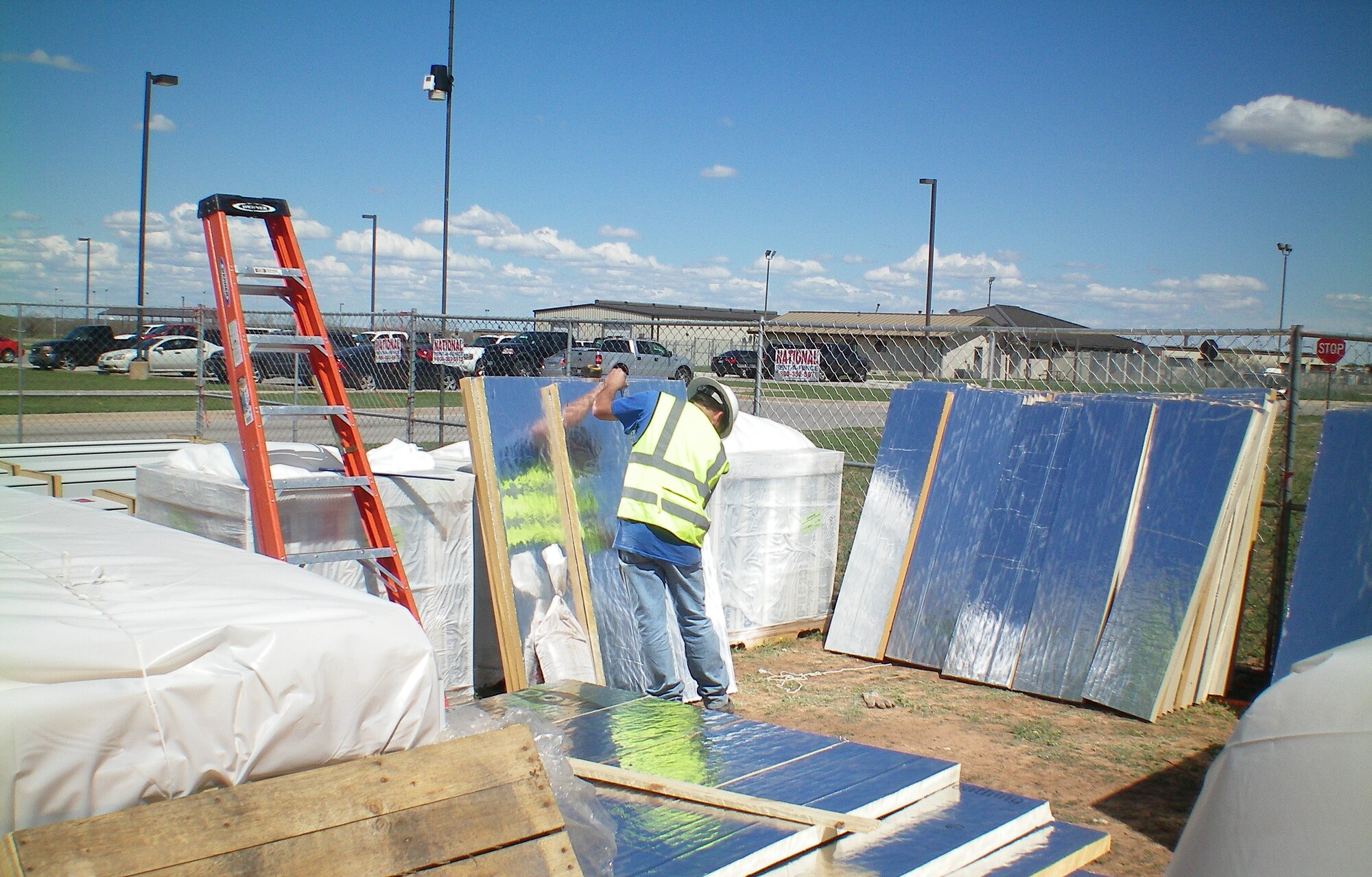 GOODFELLOW AIR FORCE BASE, Texas - A contractor measures and cuts the high density rigid insulation boards that were used on the new Security Forces building roof. (U.S. Air Force photo/Brian Mousavi)
