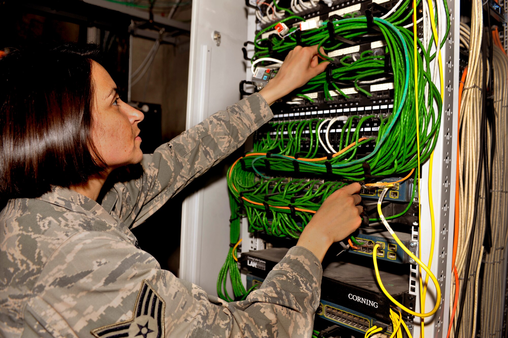 BAGRAM AIRFIELD, Afghanistan— Staff Sgt. Christina Herrera examines category five cables at Bagram Airfield, Afghanistan, April 3, 2012. Herrera is noncommissioned officer in charge of the Medical Information Systems Help Desk with the 455th Expeditionary Medical Support Squadron and is deployed from Lackland Air Force Base, Texas. (U.S. Air Force photo/Airman 1st Class Ericka Engblom)
