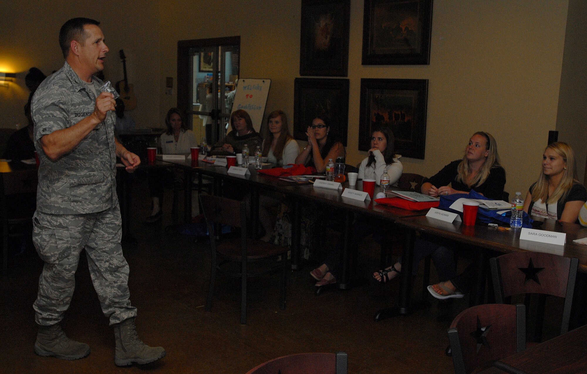 GOODFELLOW AIR FORCE BASE, Texas-- Col. Paul Bugenske, 17th Mission Support Group Commander, explains the story behind Challenge Coins to Heart Link members March 29. Heart Link is an Air Force spouse orientation program designed to strengthen families and enhance mission readiness for all military services. (U.S. Air Force photo/ Airman 1st Class Michael Smith)
