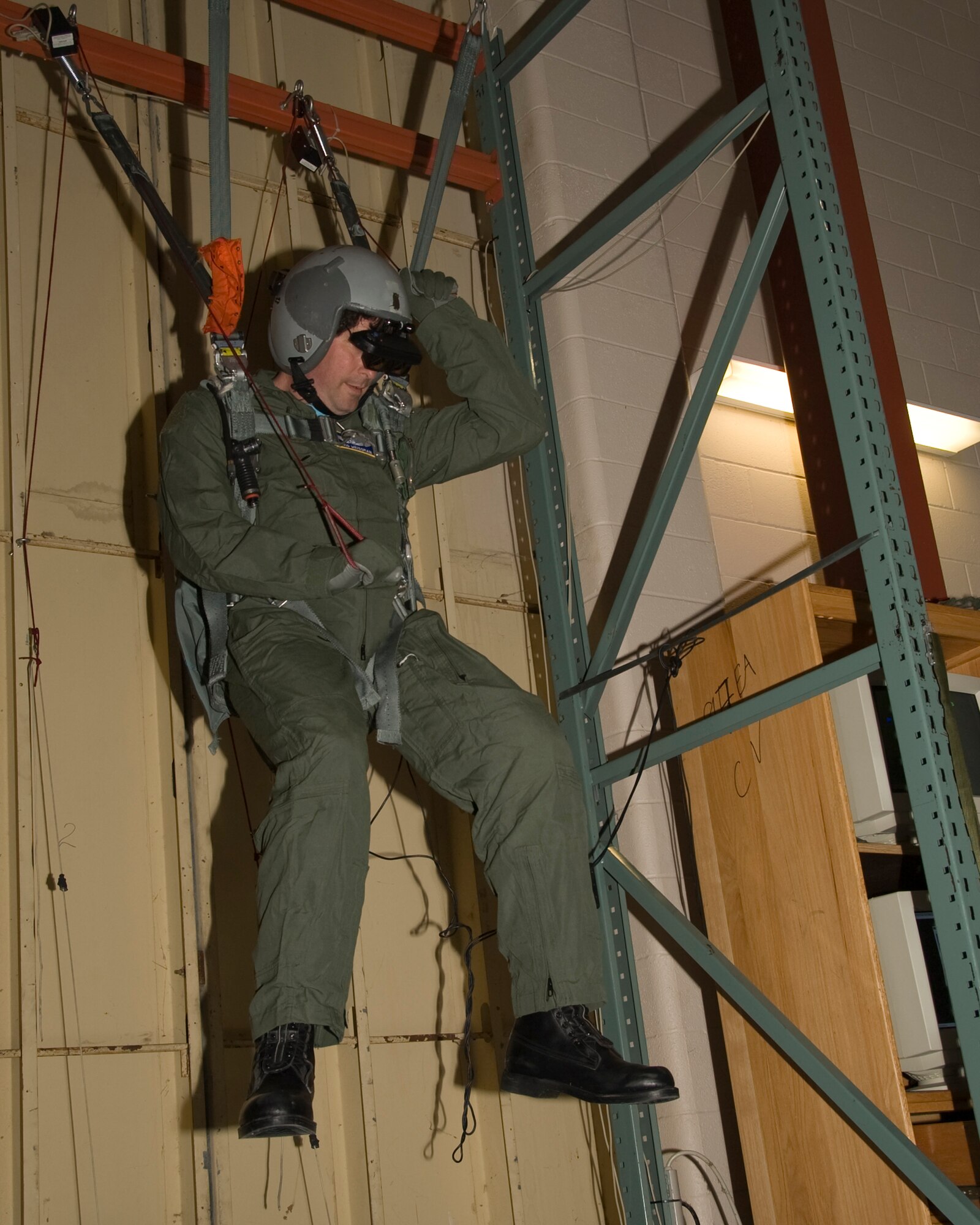 David Weissman, a Montana businessman, hangs in a harness of a parachute simulator on Barksdale Air Force Base, La., April 2. The parachute simulator is used to give aircrew members the training they need to operate a parachute during a real-life situation. (U.S. Air Force photo/Airman 1st Class Benjamin Gonsier)(RELEASED)
