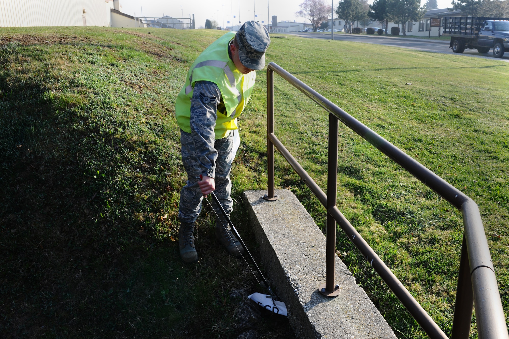 SPANGDAHLEM AIR BASE, Germany – Airman 1st Class Nicholas Chapman, 52nd Equipment Maintenance Squadron aircraft armament apprentice, picks up a piece of paper during his morning Eifel Pride trash route near Arnold Boulevard here April 3. Eifel Pride is a mandatory two-week program for first-term Airmen stationed here immediately following initial technical training school. The program helps Airmen become oriented to the base, allows them to finish their in-processing and aids in the ongoing 52nd Fighter Wing goal of becoming United States Air Forces in Europe’s most environmentally-friendly wing. (U.S. Air Force photo by Airman 1st Class Dillon Davis/Released)