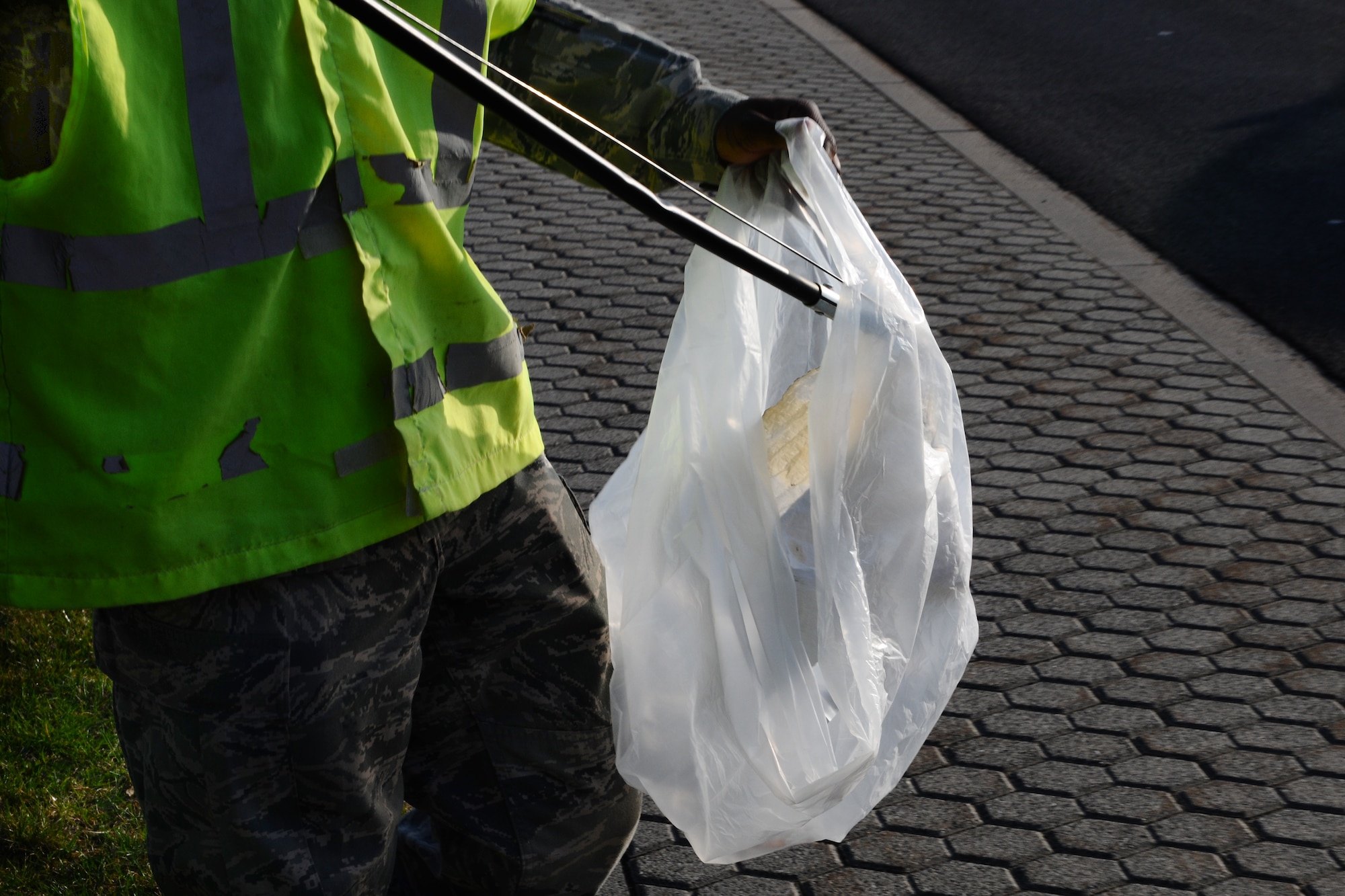 SPANGDAHLEM AIR BASE, Germany – Airman 1st Class Brian Darden, 52nd Logistics Readiness Squadron customer service apprentice, puts a piece of paper in a garbage bag during his morning Eifel Pride trash route near Arnold Boulevard here April 3. Eifel Pride is a mandatory two-week program for first-term Airmen stationed here immediately following initial technical training school. The program helps Airmen become oriented to the base, allows them to finish their in-processing and aids in the ongoing 52nd Fighter Wing goal of becoming United States Air Forces in Europe’s most environmentally-friendly wing. (U.S. Air Force photo by Airman 1st Class Dillon Davis/Released)
