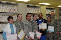 MINOT AIR FORCE BASE, N.D. -- From left to right: Kim Lemley, Senior Airman Elena Hughes, Senior Airman Jose Davila, Senior Airman Michelle Partridge, Demorris Harper, Staff Sgt. Lorry Arellano, Chief Master Sgt. Kevin Jurgella

The Outpatient Medical Records section at the 5th Medical Group is responsible for maintaining medical records for the more than 12,000 beneficiaries here at Minot Air Force Base. The 8-person team performs management functions during in- and out-processing, patient registration, filing and researching, as well as customer service on a daily basis. Records technicians also request, receive and file patient information received from off-base provider visits to ensure each member's medical records contain a complete history of care. Their ultimate focus is on providing the vital documents needed to maintain the health and well-being of Team Minot members, as they support and execute the dual wing nuclear mission. (Photo Submission/Tech. Sgt. Mark Frederici)
