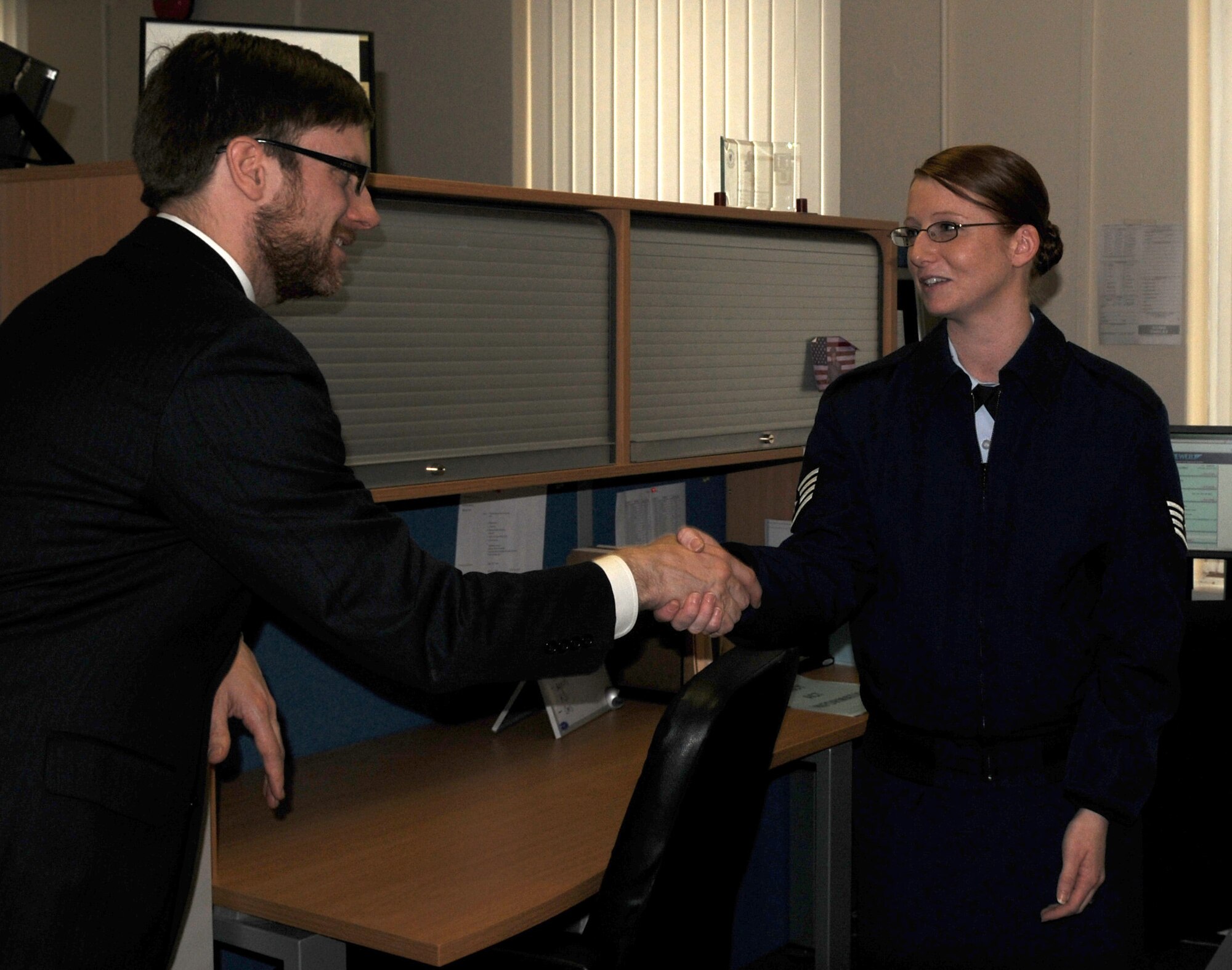 RAF MILDENHALL, England –Jamie Morin, Assistant Secretary of the Air Force for Financial Management and Comptroller, presents a finance management office coin, during a visit to RAF Mildenhall, to Staff Sgt. Tiffany Thompson, 100th Comptroller Squadron, for being an exceptional performer April 2, 2012. Morin met with comptroller Airmen from Team Mildenhall and RAF Lakenheath during his visit to Europe. (U.S. Air Force photo/Senior Airman Rachel Waller)