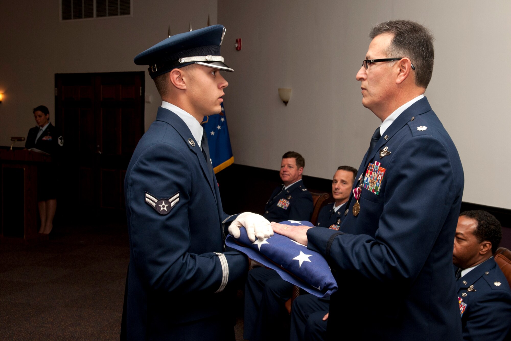An American flag is presented to U.S. Air Force Lt. Col. Rafael Rodriguez during a retirement ceremony at Barksdale Air Force Base, La., April 1, 2012. Rodriguez is a B-52 radar navigator assigned to the 343rd Bomb Squadron and is retiring from the Air Force reserve with more than 5,400 flying hours in the aircraft. (U.S. Air Force photo by Master Sgt. Greg Steele/Released)