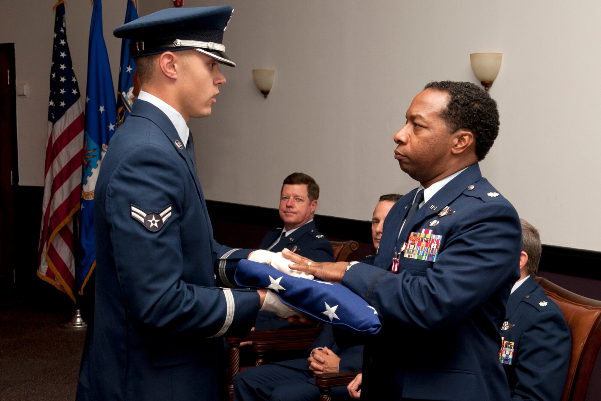 An American flag is presented to U.S. Air Force Lt. Col. Chris Myers during a retirement ceremony at Barksdale Air Force Base, La., April 1, 2012. Myers, a B-52 navigator assigned to the 343rd Bomb Squadron, is retiring from the Air Force Reserve and has over 4,000 flying hours in the B-52. (U.S. Air Force photo by Master Sgt. Greg Steele/Released)