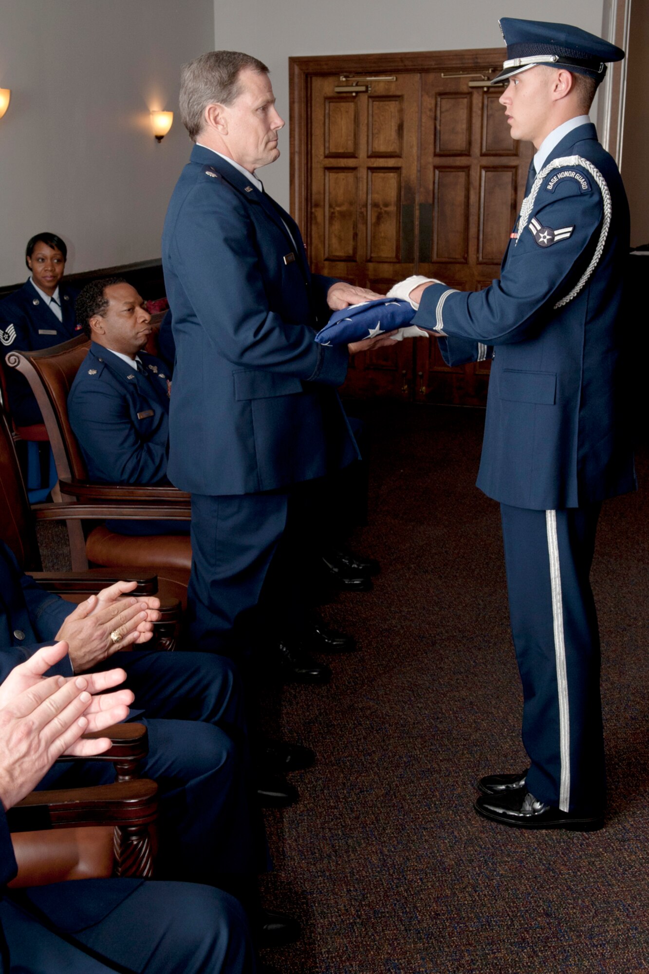 An American flag is presented to U.S. Air Force Lt. Col. Chris Rounds during a retirement ceremony at Barksdale Air Force Base, La., April 1, 2012. Rounds, a B-52 navigator assigned to the 93rd Bomb Squadron, is retiring from the Air Force Reserve with over 5,700 flying hours in the B-52. (U.S. Air Force photo by Master Sgt. Greg Steele/Released)