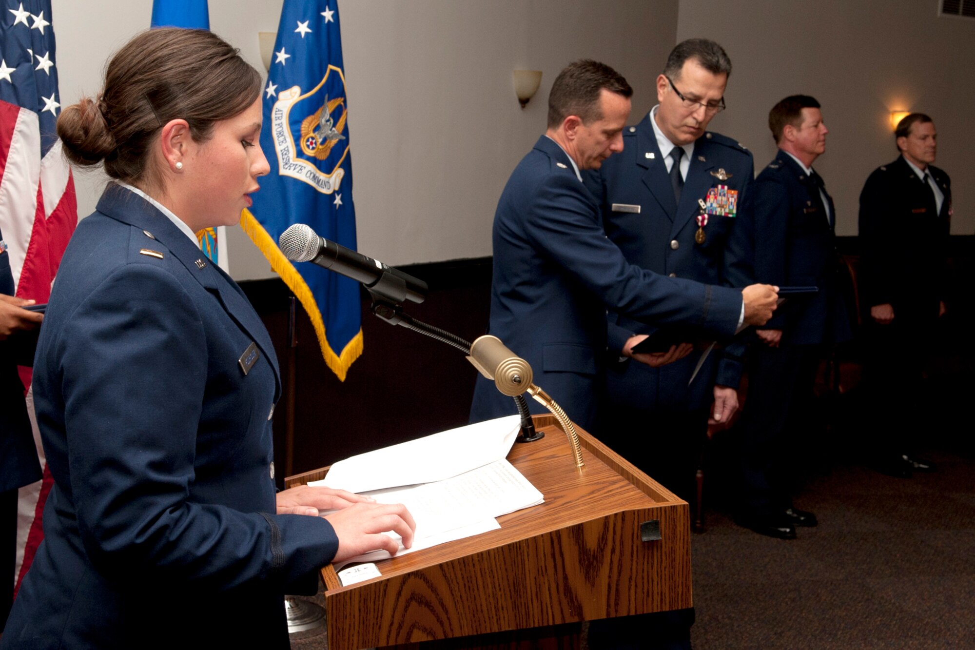 U.S. Air Force 2nd Lt. Beverly Rodriguez reads as her dad, Lt. Col. Rafael Rodriguez, is presented the retirement certificate during a ceremony at Barksdale Air Force Base, La., April 1, 2011. Lt. Col. Rodriguez is a radar navigator assigned to the 343rd Bomb Squadron and is retiring from the Air Force Reserve. (U.S. Air Force photo by Master Sgt. Greg Steele/Released)