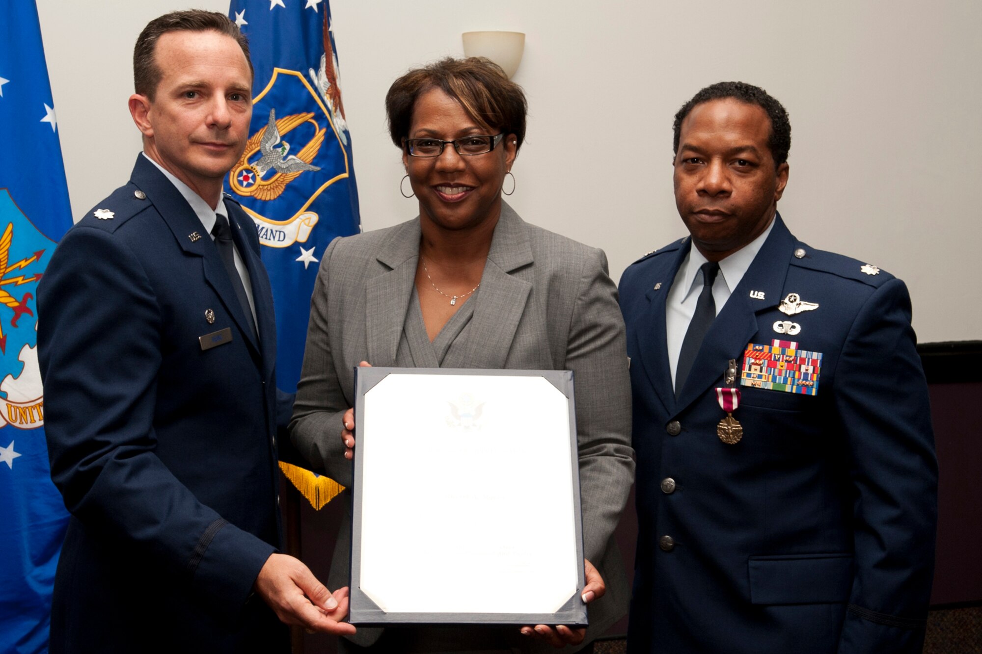Sherri Myers is presented the spouse appreciation certificate during her husband's retirement ceremony at Barksdale Air Force Base, La., April 1, 2012. Myers is married to Lt. Col. Chris Myers, a B-52 navigator assigned to the 343rd Bomb Squadron. (U.S. Air Force photo by Master Sgt. Greg Steele/Released)