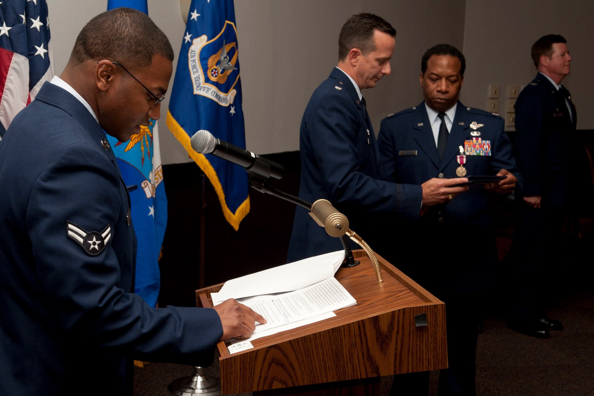U.S. Air Force Airman 1st Class Christopher Myers reads as his dad, Lt. Col. Chris Myers, is presented the retirement certificate during a ceremony at Barksdale Air Force Base, La., April 1, 2012. Myers is a B-52 navigator assigned to the 343rd Bomb Squadron and is retiring from the Air Force Reserve. (U.S. Air Force photo by Master Sgt. Greg Steele/Released)