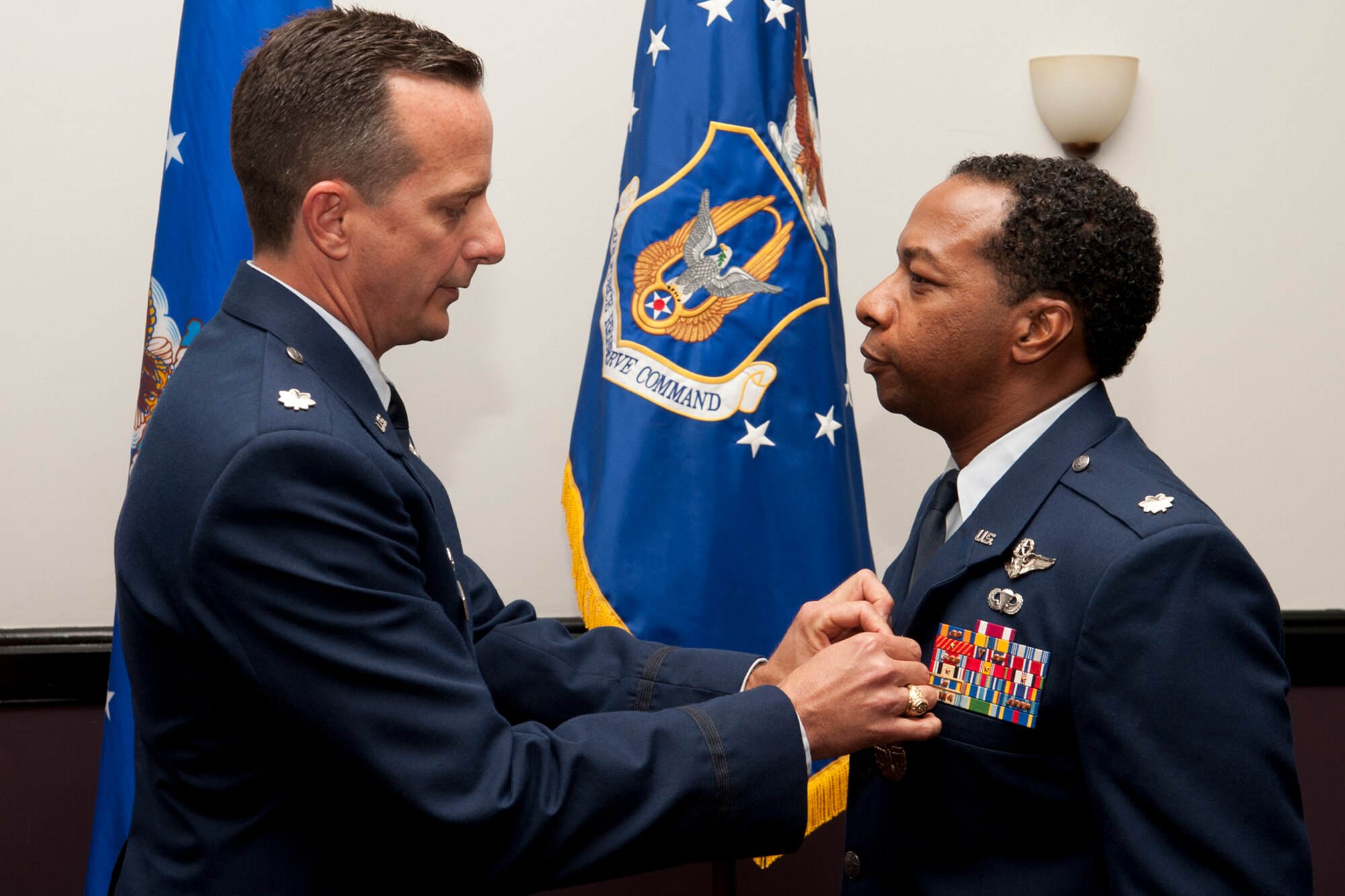 U.S. Air Force Lt. Col. Denis Heinz, 343rd Bomb Squadron commander, presents the Air Force Meritorious Service Medal to Lt. Col. Chris Myers during a retirement ceremony at Barksdale Air Force Base, La., April 1, 2012. Myers is a B-52 radar navigator and is retiring from the Air Force Reserve. (U.S. Air Force photo by Master Sgt Greg Steele/Released)