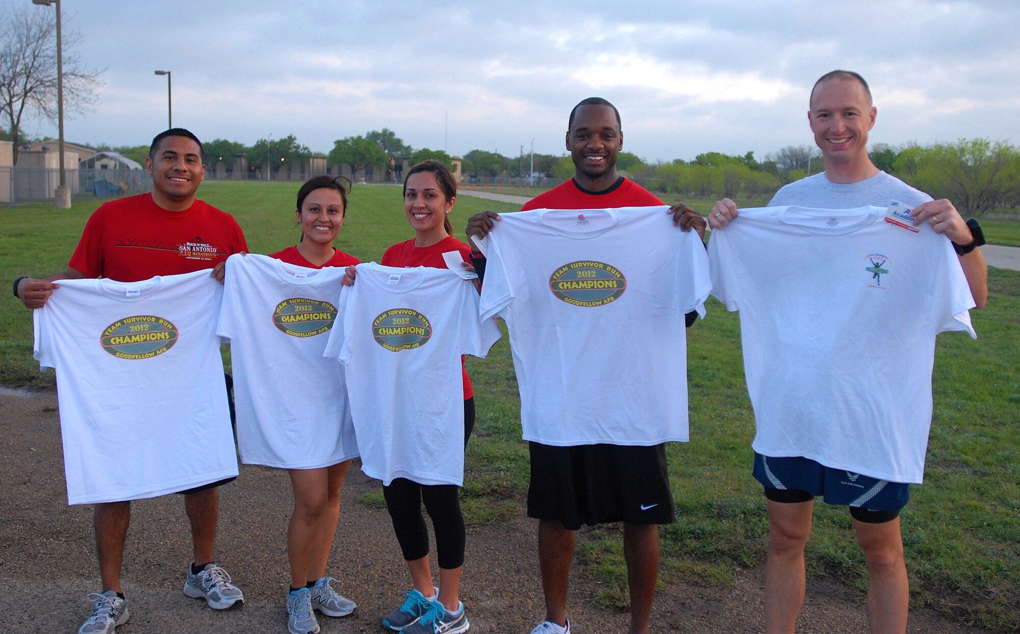 GOODFELLOW AIR FORCE BASE, Texas-- Team Sabers and Master Sgt. Douglas Hackelton, 315th Training Squadron, pose with their champion T-shirts after winning the 2012 Survivor Run, March 30. The three mile run also included three challenges that tested the competitors mentally and physically. (U.S. Air Force photo/ Airman 1st Class Michael Smith)