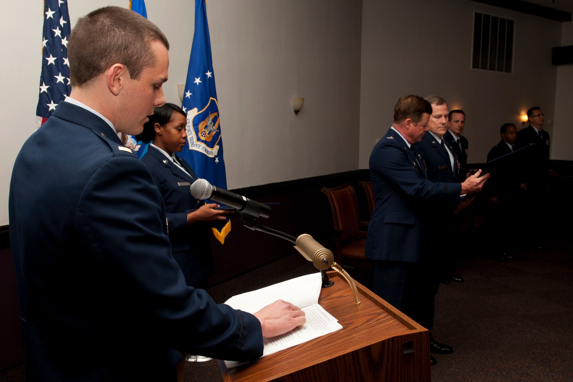 U.S. Air Force 2nd Lt. Matthew Rounds reads as the retirement certificate is presented to his dad, Lt. Col. Chris Rounds, during a retirement ceremony at Barksdale Air Force Base, La., April 1, 2012. Rounds is a navigator assigned to the 93rd Bomb Squadron and is retiring from the Air Force Reserve. (U.S. Air Force photo by Master Sgt. Greg Steele/Released)