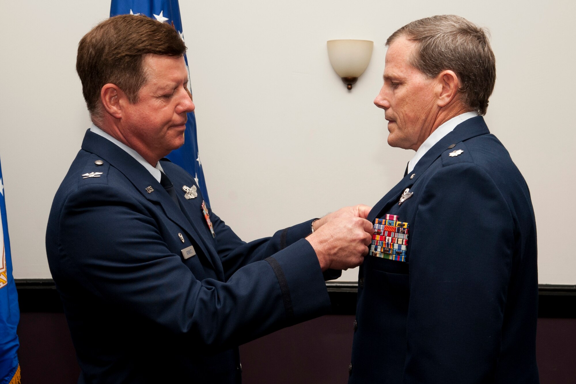U.S. Air Force Col. Keith Schultz, 307th Operations Group commander, presents the Air Force Meritorious Service Medal to Lt. Col. Chris Rounds during a retirement ceremony at Barksdale Air Force Base, La., April 1, 2012. Rounds is a navigator assigned to the 93rd Bomb Squadron and is retiring from the Air Force Reserve with over 5,700 flying hours in the B-52, which consists of over 500 combat hours in support of Operation Enduring Freedom and Operation Iraqi Freedom. (U.S. Air Force photo by Master Sgt. Greg Steele/Released)