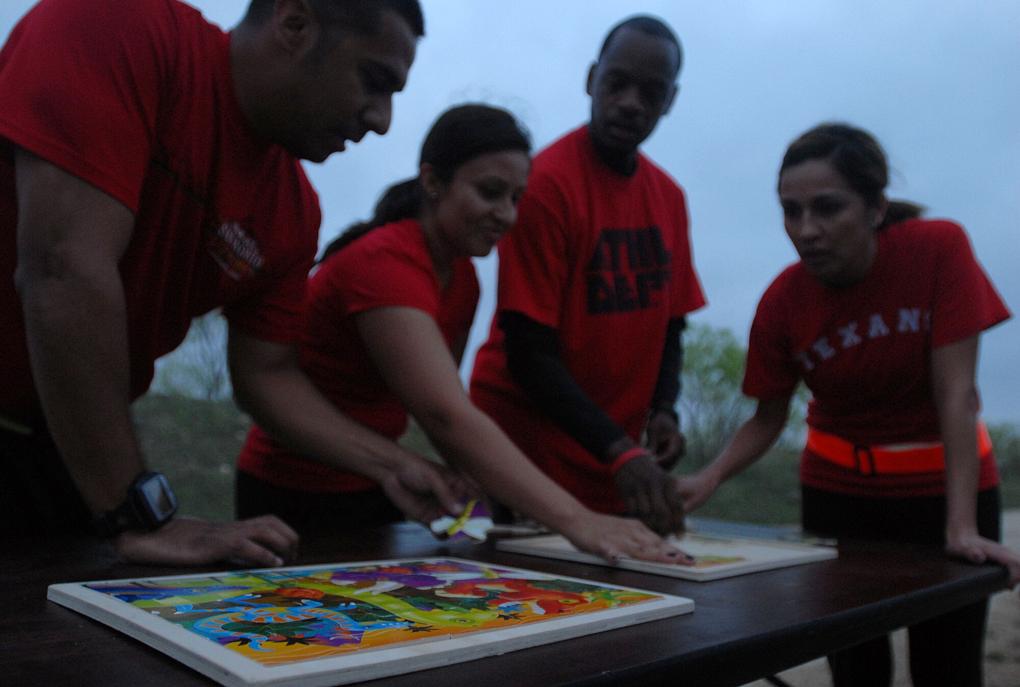 GOODFELLOW AIR FORCE BASE, Texas-- Team Sabers come together to complete the final challenge of the 2012 Survivor Run, March 30. The challenge involved the team completing a puzzle, after running a mile and a half. (U.S. Air Force photo/ Airman 1st Class Michael Smith)
