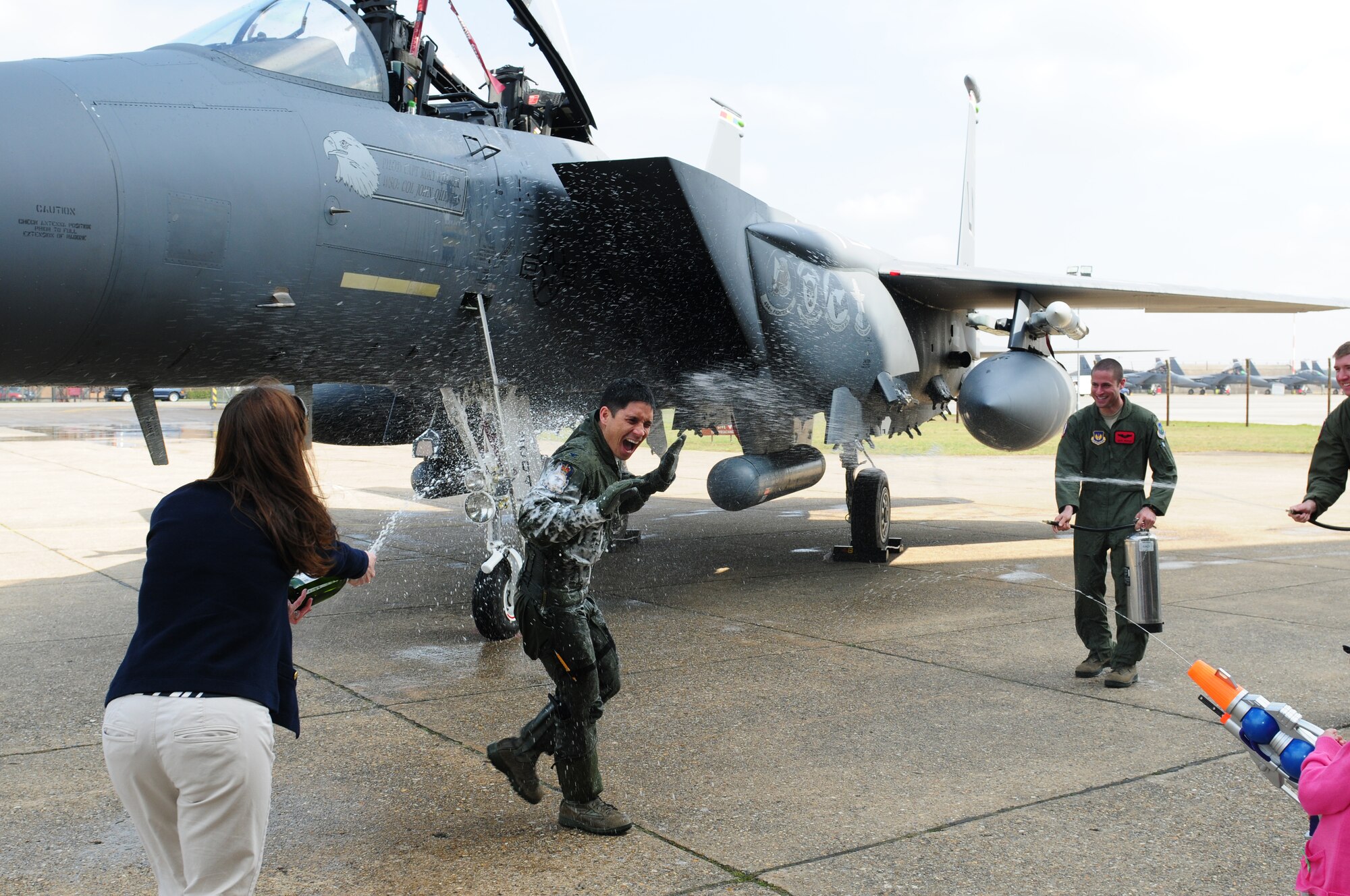 ROYAL AIR FORCE LAKENHEATH, England – Col. John Quintas, 48th Fighter Wing commander, is sprayed with water and champagne after his “fini” flight April 2, 2012. Quintas took his final flight as the Liberty Wing commander in an F-15E Strike Eagle piloted by Col. Daniel Orcutt, 48th Operations Group commander. (U.S. Air Force photo by Airman 1st Class Cory D. Payne)