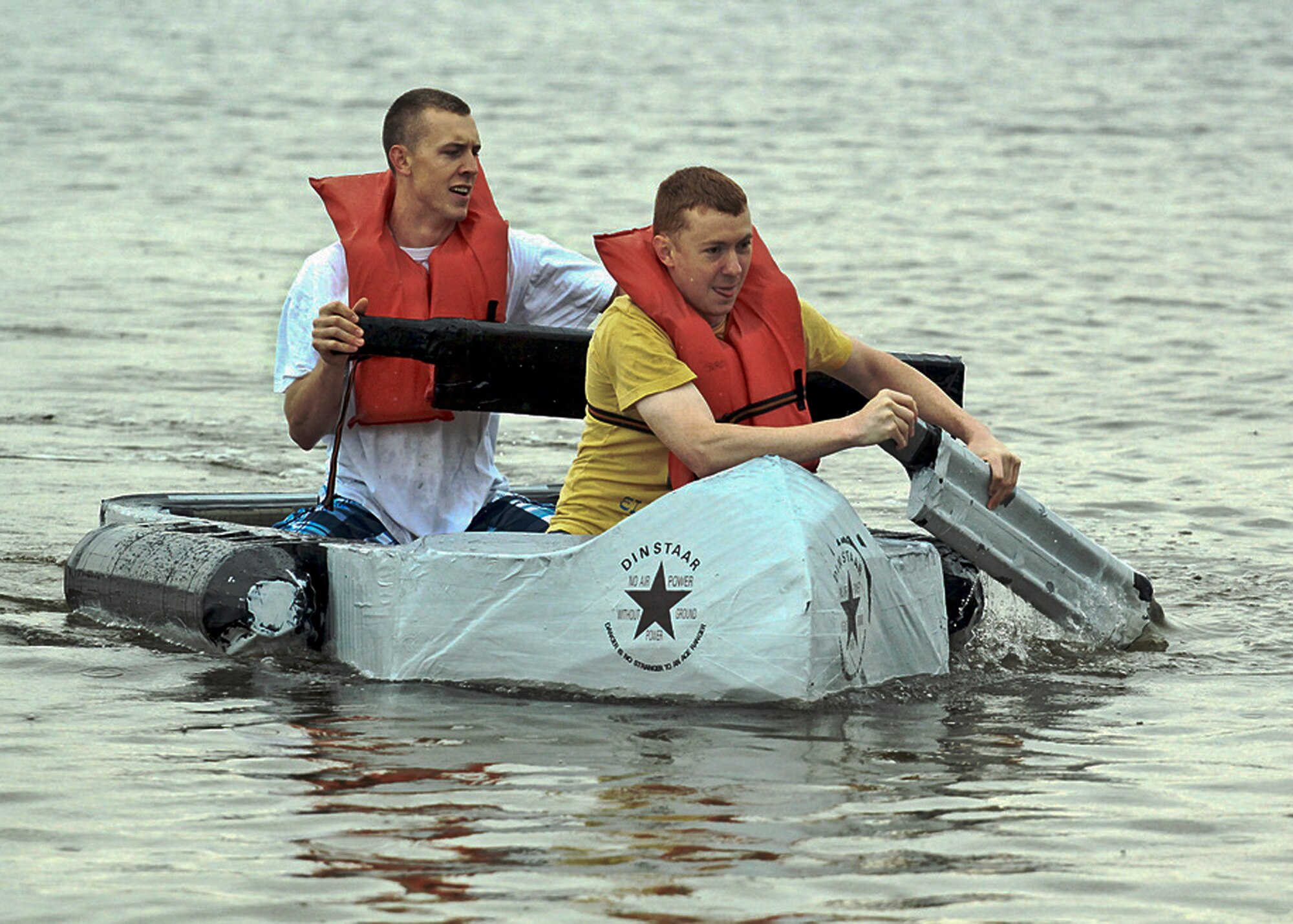William Wilson and Drew Hamilton of Team Dinstar row to victory at the cardboard boat regatta race March 31 at Eglin Air Force Base, Fla.  Eight teams competed at this year's race.  (Courtesy photo/Senior Airman Mitchell Forde)