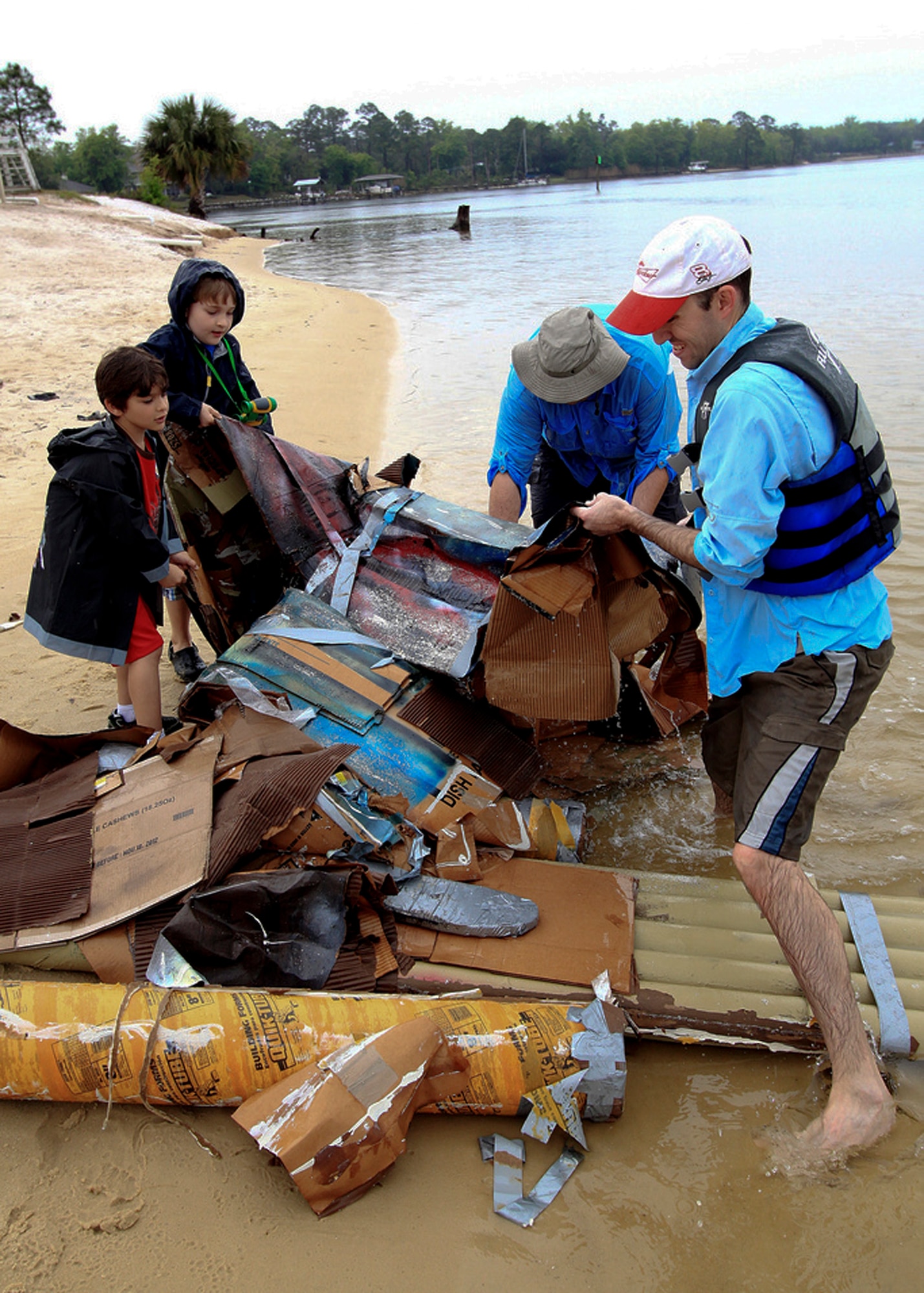 Third place finishers, the Tree Shakers, salvage what is left of their boat during the cardboard boat regatta race March 31 at Eglin Air Force Base, Fla.  Eight teams competed at this year's race.  (Courtesy photo/Senior Airman Mitchell Forde)