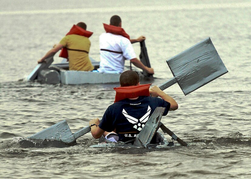 Christopher Berglund tries hard to keep up with Team Dinstar, the winners of the cardboard boat regatta race March 31 at Eglin Air Force Base, Fla.  Eight teams competed at this year's race.  (Courtesy photo/Senior Airman Mitchell Forde)