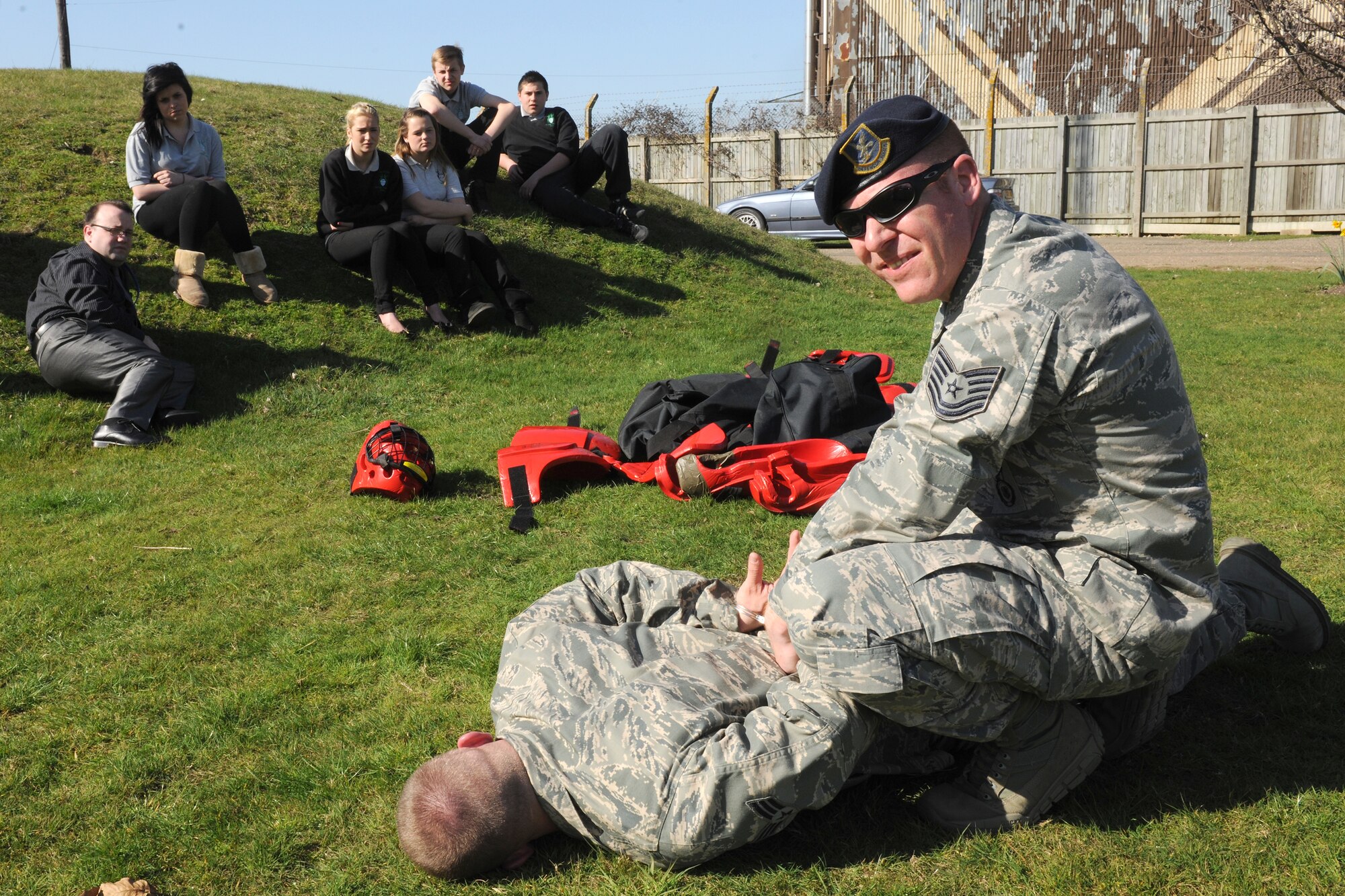 RAF ALCONBURY, United Kingdom - Tech. Sgt. Michael Hall shows students from The Manor a handcuffing demonstration outside the 423rd Security Forces Squadron building March 27. The students were shown different activities the Defenders from the 423rd SFS do on a day-to-day basis. Airmen from the 423rd SFS participate in a weekly-mentorship program with the students. (U.S. Air Force photo by Senior Airman Joel Mease)
