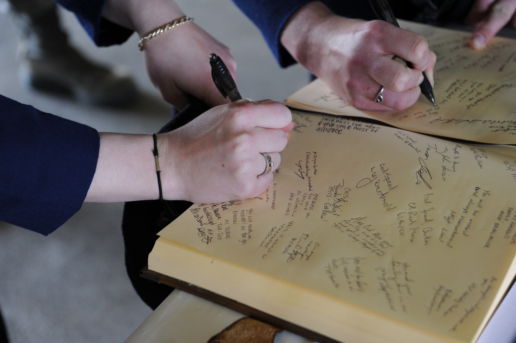 Guests sign the attendance registry during the memorial for Airman 1st Class Joel Barrow March 30, 2012, at Incirlik Air Base, Turkey. The ceremony honored the life of Barrow, a 39th Security Forces Squadron security response team member who died March 27. (U.S. Air Force photo by Senior Airman Jarvie Z. Wallace/Released) 