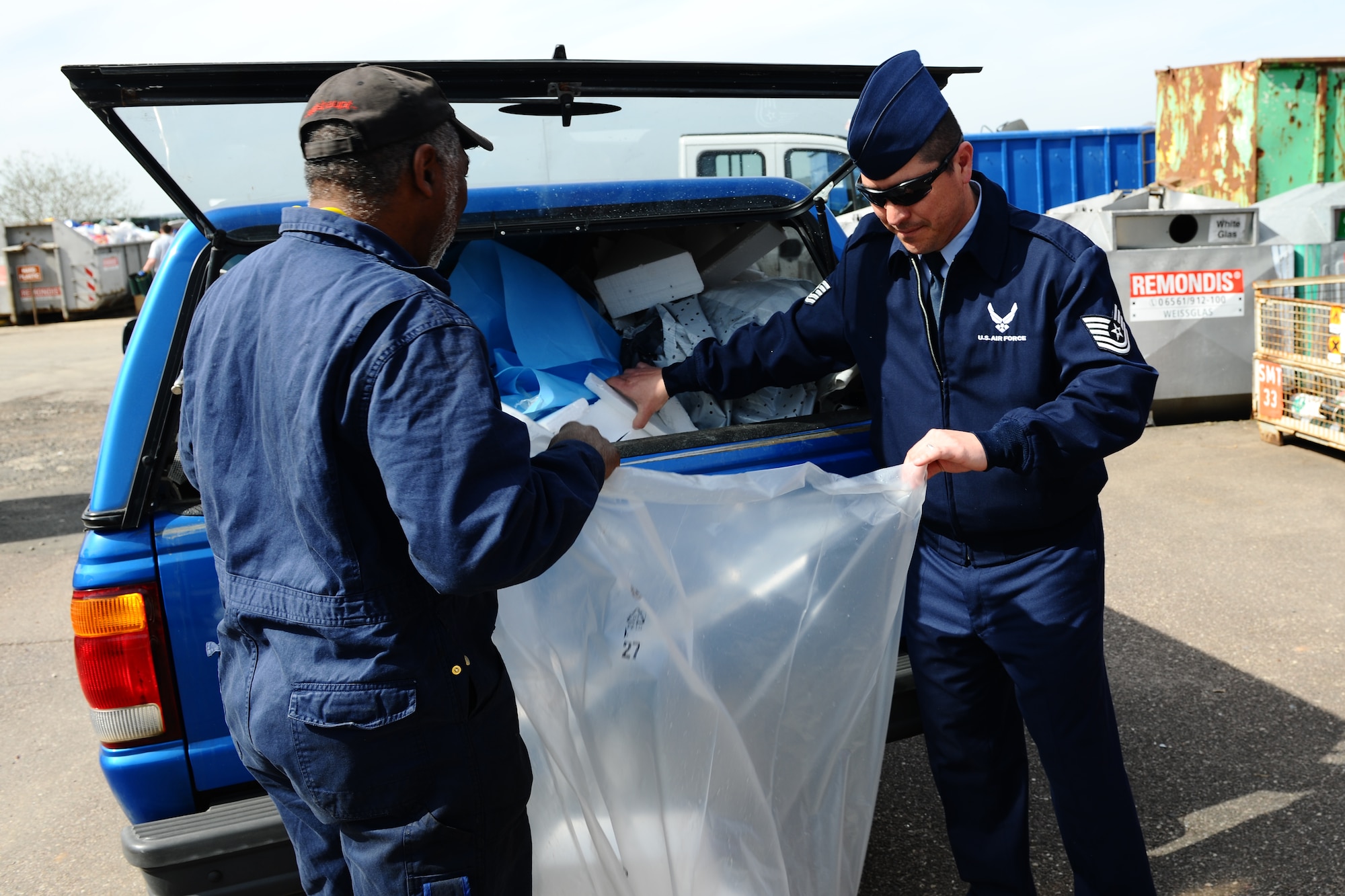 SPANGDAHLEM AIR BASE, Germany – Floyd Winbush, left, 52nd Force Support Squadron Auto Hobby Shop mechanic, and Tech. Sgt. Lewis Isassi, 52nd Civil Engineer Squadron contract office representative, sort through plastic foam and plastic at the recycling center here April 2 before the materials can be placed in their respective recycling bins. Materials must be sorted into separate bins so they don’t contaminate one another during the recycling process. The recycling center gives base members a solution for unwanted reusable wastes ranging from paper to half-full aerosol cans. The center is open 11 a.m. – 5 p.m. Monday, Tuesday and Friday; 9 a.m. – 6 p.m. Thursday; and 9 a.m. – 4 p.m. Saturday. (U.S. Air Force photo by Airman 1st Class Dillon Davis/Released)
