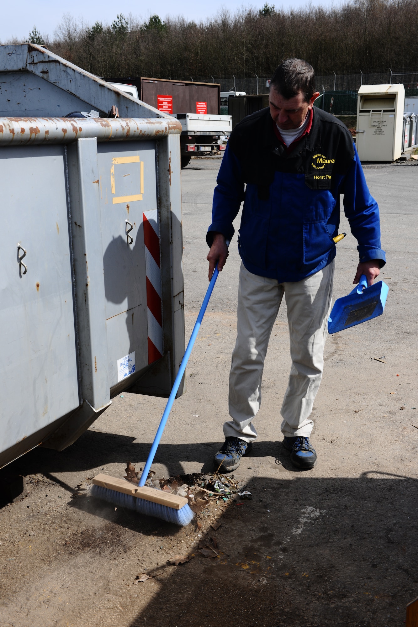 SPANGDAHLEM AIR BASE, Germany – Horst Thiel, 52nd Civil Engineer Squadron Recycling Center manager, sweeps dirt and garbage into a pile at the recycling center here April 2. Thiel sweeps the areas surrounding the recycling bins to keep walkways free of hazardous debris and present a clean appearance. The recycling center gives base members a solution for unwanted reusable wastes ranging from paper to half-full aerosol cans. The center is open 11 a.m. – 5 p.m. Monday, Tuesday and Friday; 9 a.m. – 6 p.m. Thursday; and 9 a.m. – 4 p.m. Saturday. (U.S. Air Force photo by Airman 1st Class Dillon Davis/Released)