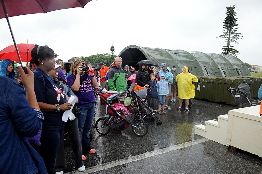 Despite rainy weather, military families come out to march during the second annual March of Dimes, March for Babies event on Kadena Air Base, March 31, 2012. Kadena raised more than $50,000 in support of finding cures for infant mortality rates and helping mothers have full-term pregnancies. (U.S. Air Force photo by Airman 1st Class Brooke P. Beers/Released)