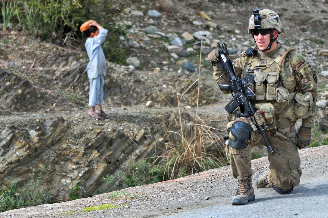 U.s. Army Staff Sgt. Andrew Preston Takes A Knee While Providing 