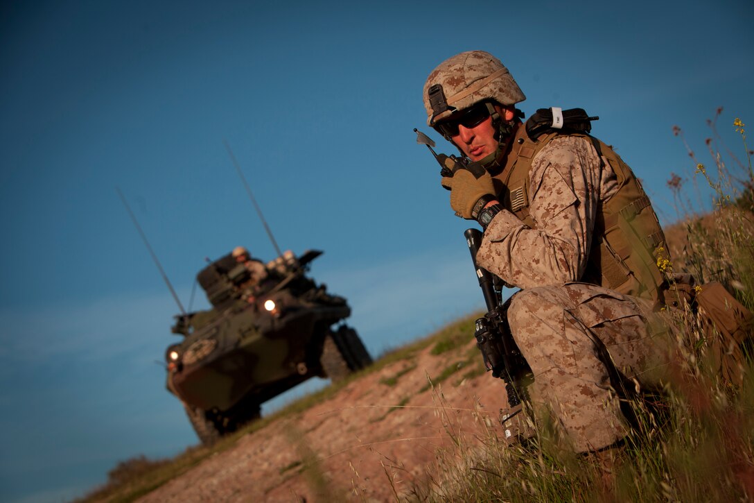 Staff Sgt. Brian Sears, Weapons Company, Battalion Landing Team, 3rd Battalion, 5th Marines, 15th Marine Expeditionary Unit relays a status update to his platoon commander during a simulated tactical recovery of personnel scenario. This particular scenario was created by the Command Element to develop the skills of the TRAP unit. The task at hand was to recover two United States Agency for International Development workers after a medical aid mission went wrong.
