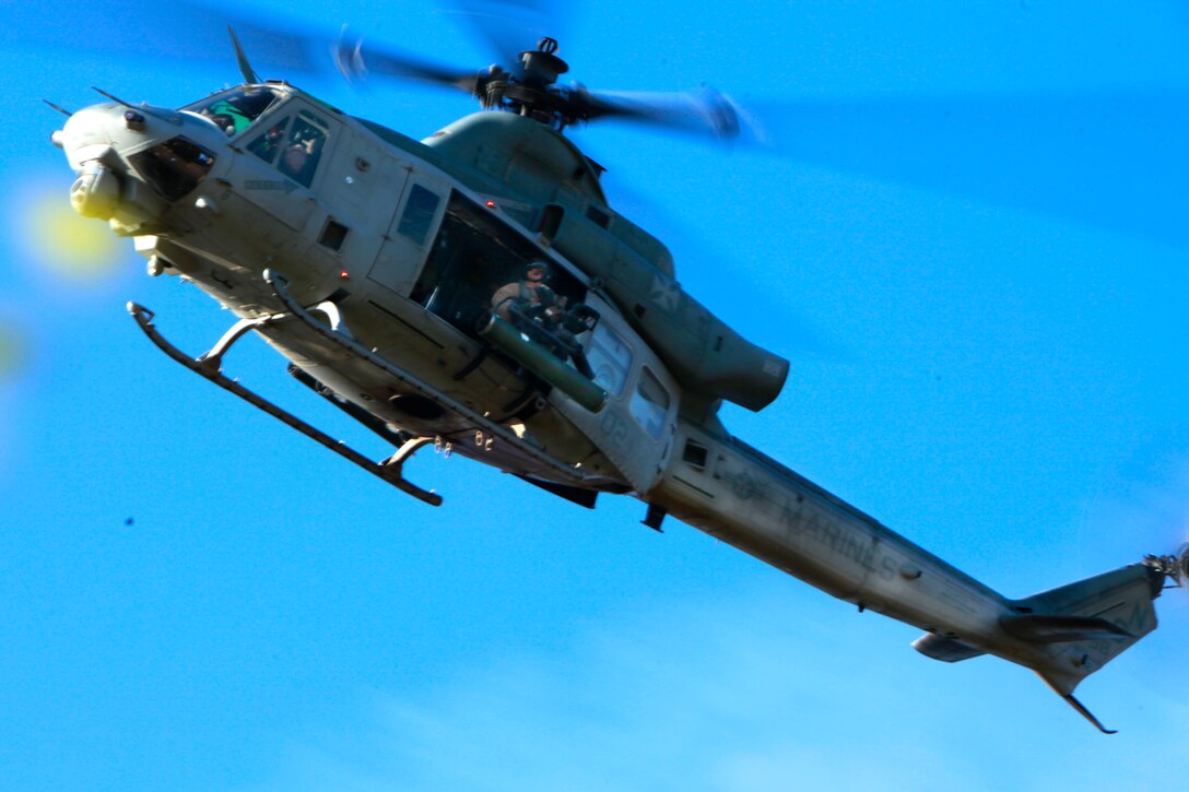 A UH-1Y with Marine Medium Helicopter Squadron 364 flies over the area in search of two role players acting as United States Agency for International Development workers as a part of a tactical recovery of personnel during MEU Exercise, April 4. Marine Expeditionary Unit Exercise is the first training that integrates all elements of the Marine Air Ground Task Force. Tactical recovery of aircraft and personnel missions are rehearsed using several training scenarios. This particular scenario was created by the Command Element to develop the skills of each of the role players. The task at hand was to recover two United States Agency for International Development workers after a medical aid mission went wrong.