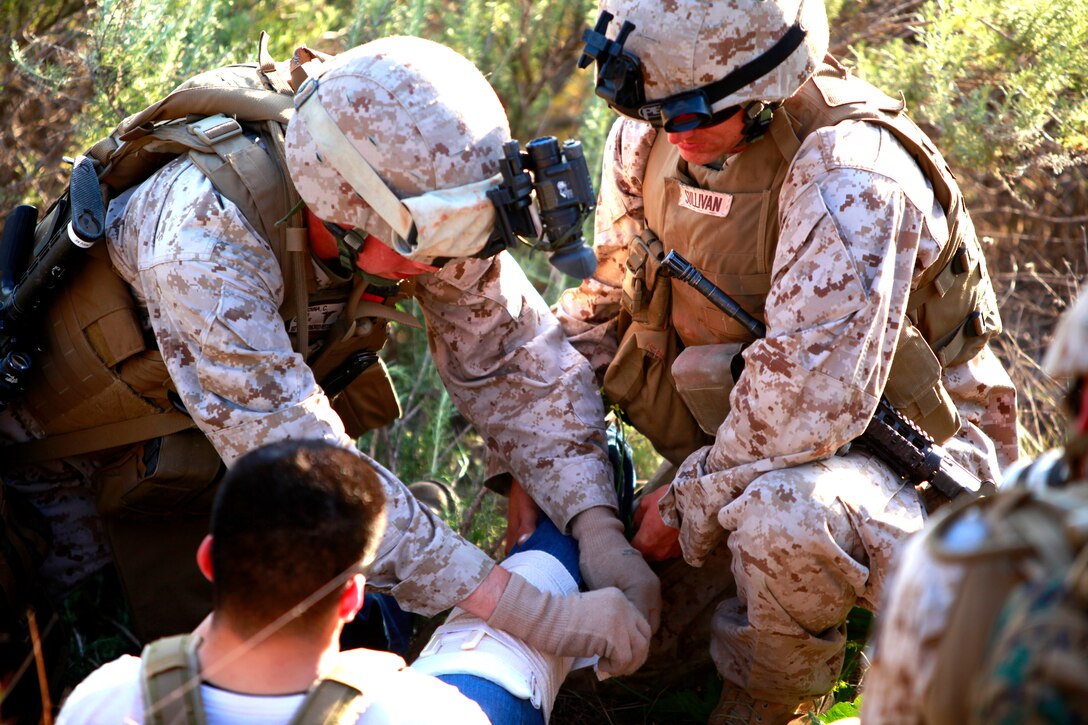 Marines and sailors with the security element for the Tactical Recovery of Aircraft and Personnel, Battalion Landing Team 3/5, 15th Marine Expeditionary Unit, give medical care to a role player during a  tactical recovery of personnel as a part of MEU Exercise, April 4. Marine Expeditionary Unit Exercise is the first training that integrates all elements of the Marine Air Ground Task Force. Tactical recovery of aircraft and personnel missions are rehearsed using several training scenarios. This particular scenario was created by the Command Element to develop the skills of the TRAP unit. The task at hand was to recover two United States Agency for International Development workers after a medical aid mission went wrong.