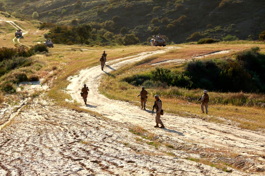 Marines with Combined Anti-Armor Team, Weapons Company, Battalion Landing Team 3/5, 15th Marine Expeditionary Unit, exit the area after rescuing role players during a tactical recovery of personnel as a part of MEU Exercise, April 4. Marine Expeditionary Unit Exercise is the first training that integrates all elements of the Marine Air Ground Task Force. Tactical recovery of aircraft and personnel missions are rehearsed using several training scenarios. This particular scenario was created by the Command Element to develop the skills of the TRAP unit. The task at hand was to recover two United States Agency for International Development workers after a medical aid mission went wrong.