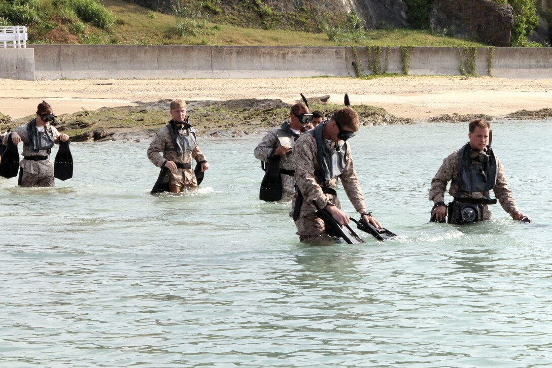 Marines with 3rd Reconnaissance Battalion enter the water to begin their 2,000-yard swim during pre-dive training at Camp Schwab April 4. The training is designed to prepare Marines for an upcoming combatant divers course. The battalion is part of 3rd Marine Division, III Marine Expeditionary Force.