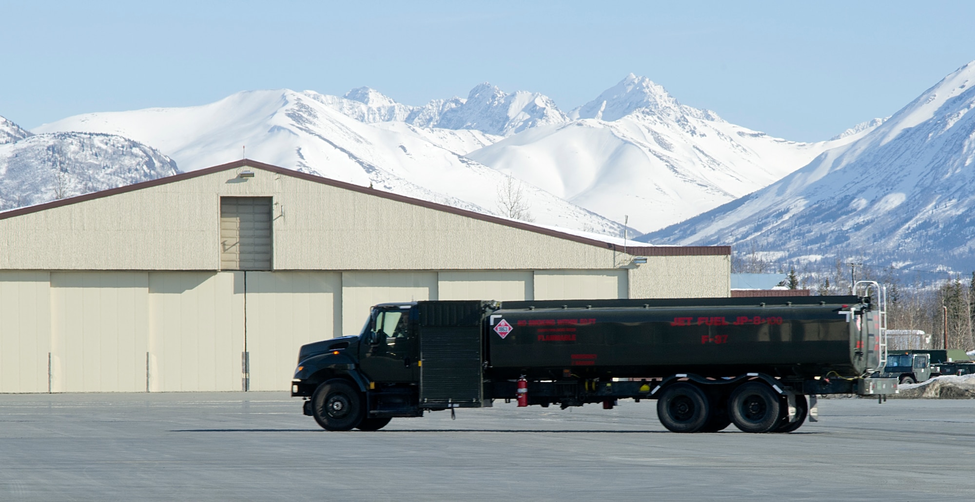 A R-11 fuel truck drives away after refueling an F-22 Raptor fighter on Joint Base Elmendorf-Richardson April 3, 2012. The R-11 fuel trucks can hold up to 6,000 gallons of fuel. (U.S. Air Force photo/Staff Sgt. Zachary Wolf)