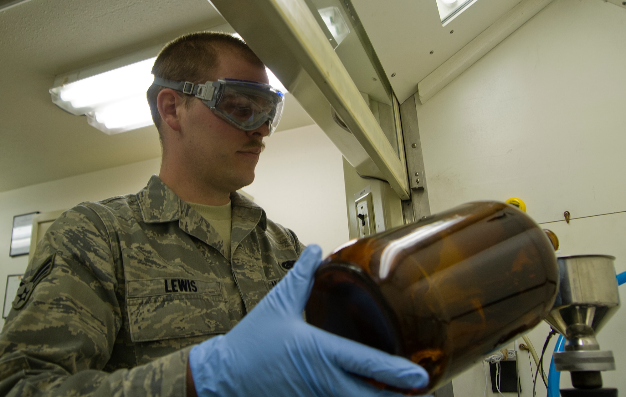 Senior Airman Nathan Lewis, 673d Logistics Readiness Squadron Petroleum, Oil, Lubricants shop laboratory technician and native of Roseburg, Ore., demonstrates how to test fuel before it is put into an aircraft on Joint Base Elmendorf-Richardson March 30, 2012. The laboratory technicians ensure the fuel is safe before it enters an aircraft to make sure it won't give the pilot any problems. (U.S. Air Force photo/Staff Sgt. Zachary Wolf)