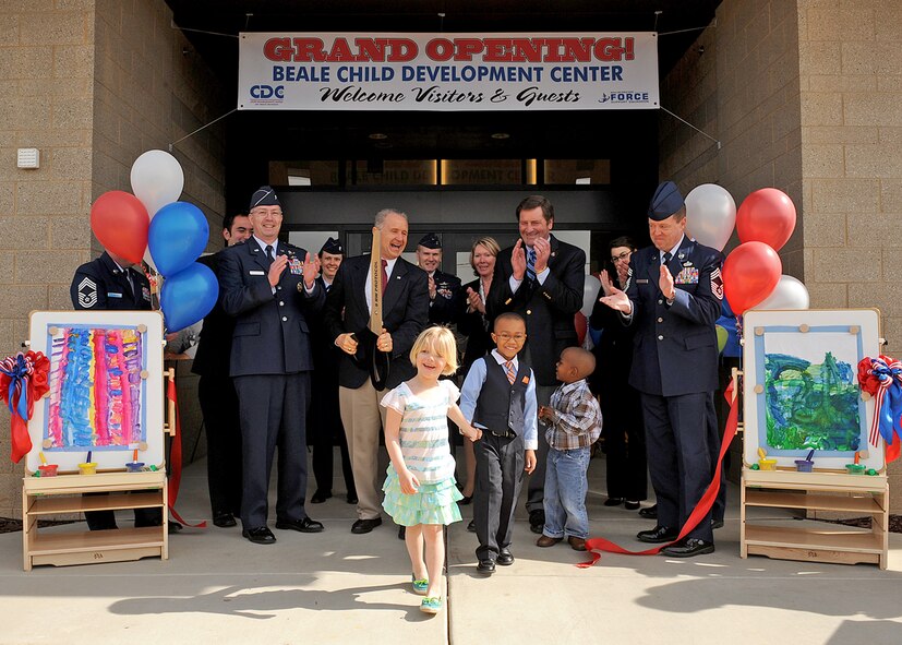 Brig. Gen. Paul McGillicuddy, 9th Reconnaissance Wing commander, base leadership, California congressional delegates, and Beale youth cut the ribbon during a ceremony celebrating the new Child Development Center at Beale Air Force Base, Calif. April 2, 2012. The new $15 million CDC, which opened March 26, can accommodate 280 children, ranging from six weeks to five years of age. (U.S. Air Force photo by Mr. John Schwab)