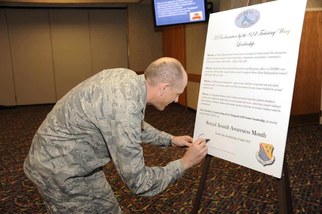 Col. Scott Chowning, 82nd Mission Support Group commander, signs the Sexual Assault Awareness Month proclamation April 3, 2012 at the Sheppard Club. The proclamation is by the 82nd Training Wing leadership stating all team Sheppard personnel are encouraged to understand the damaging effects of sexual assault on loved ones, teammates and military community fostering the theme: Hurts One-Affects All. (U.S. Air Force photo/Danny Webb)

