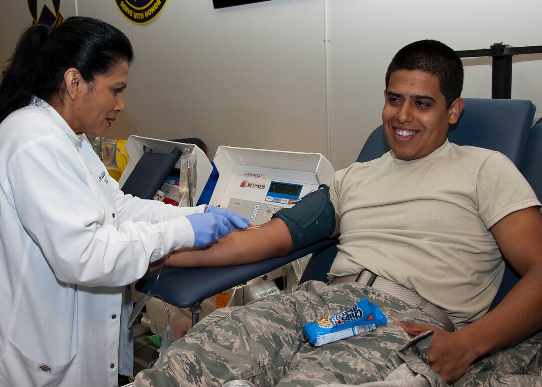 Kathy Moore of the Texas Blood Institute preps Julio Cesar Valencia, to
donate blood, a student from the 361st Training Squadron. The institute sets
up about 27 stations and draws blood from around 200-300 plus patients per
day and will be accepting donations at the Airman's Club from April 3-5 from
2-9 p.m. To donate or set up an appointment call Staff Sgt. Angelia Ashley
at (940)676-4900.  (U.S. Air Force Photo/Frank Carter)