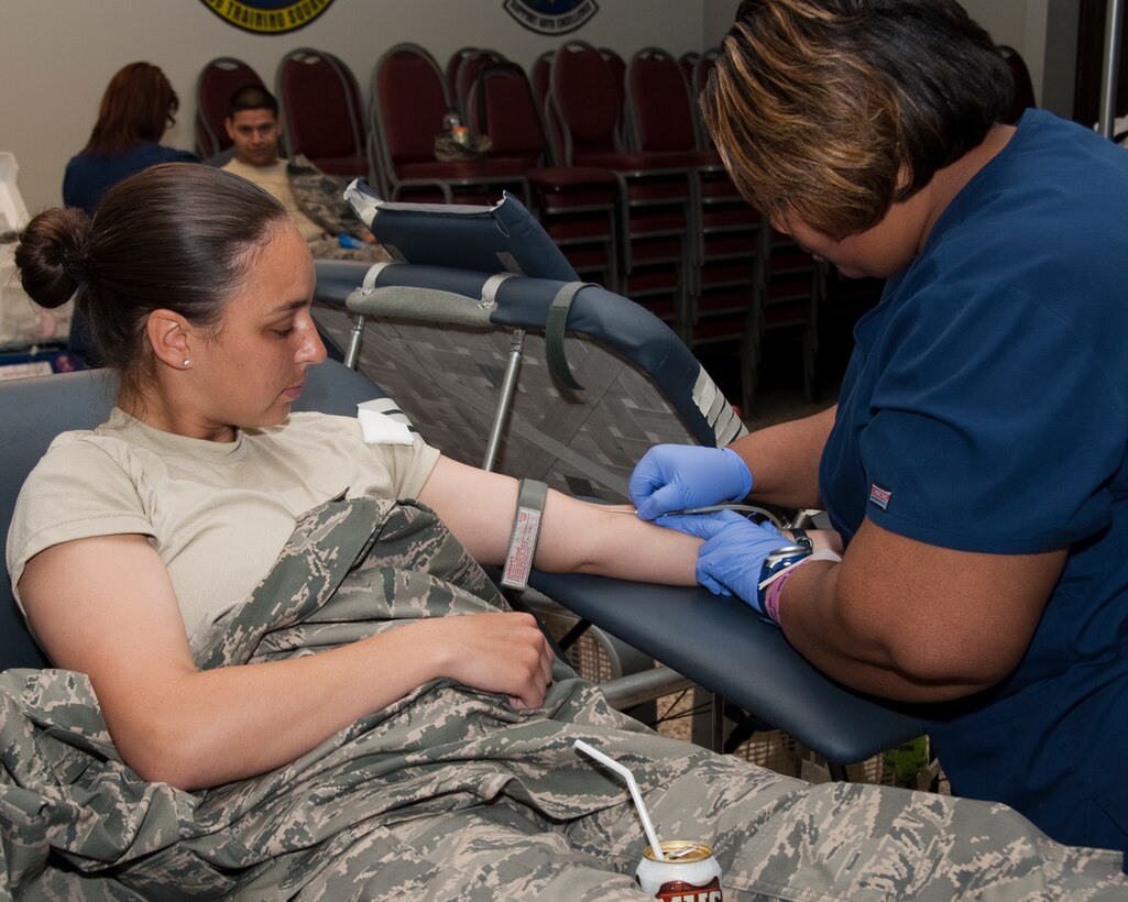 Tiffinee Gardner of the Texas Blood Institute preps Jaid Downing, to donate
blood, a student from the 361st Training Squadron. The institute sets up
about 27 stations and draws blood from around 200-300 plus patients per day
and will be accepting donations at the Airman's Club from April 3-5 from 2-9
p.m. To donate or set up an appointment call Staff Sgt. Angelia Ashley at
(940)676-4900.  (U.S. Air Force Photo/Frank Carter)