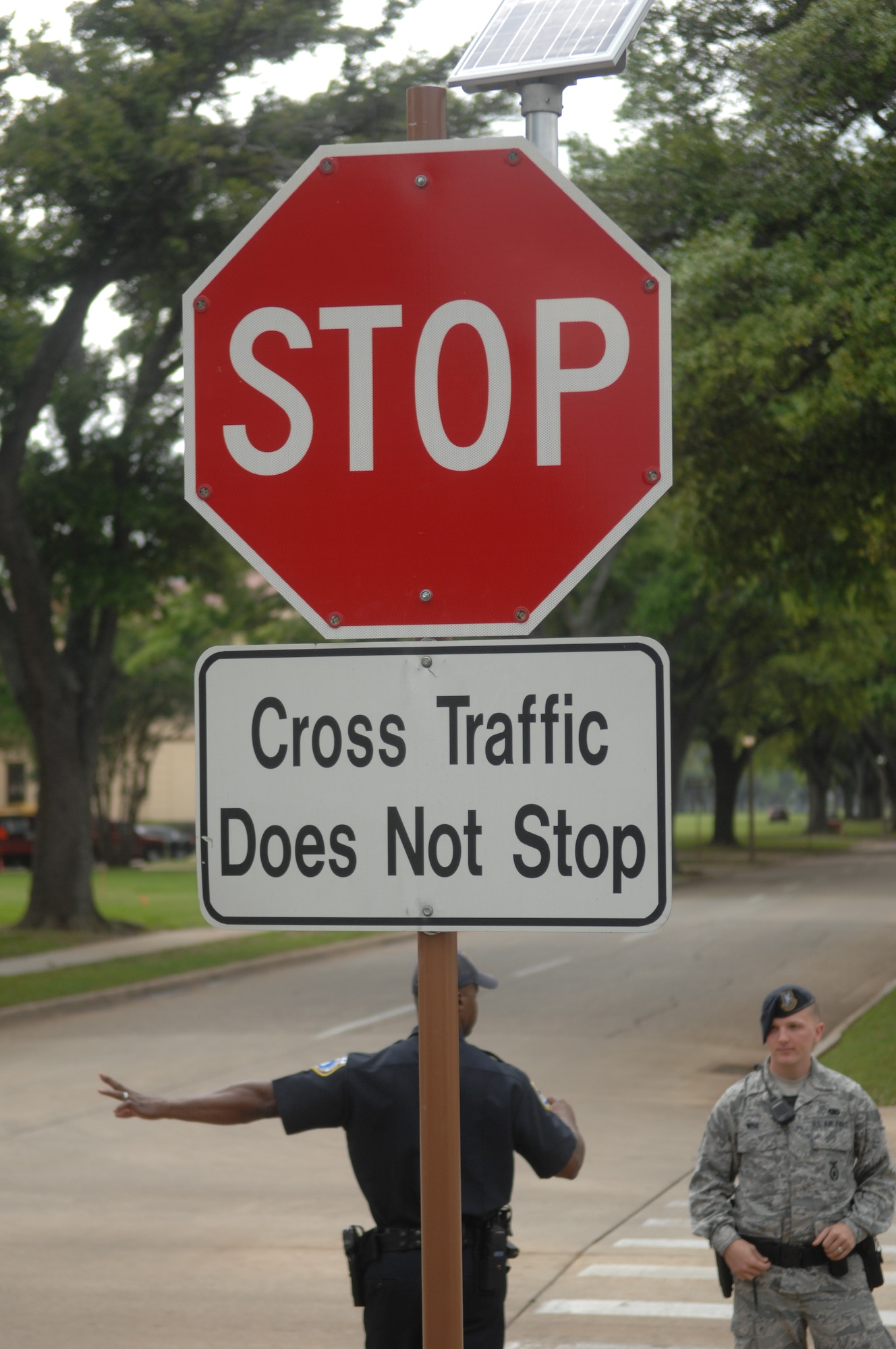 Members of 2nd Security Forces direct traffic on Barksdale Air Force Base, La., April 3. A stop sign has been added to the intersection of Davis Avenue West and Barksdale Boulevard West. Previously, traffic heading from the North Gate via Davis Avenue West had a yield sign at this intersection, but now has the right-of-way. (U.S. Air Force photo/Airman 1st Class Joseph A. Pagán Jr.)(RELEASED)