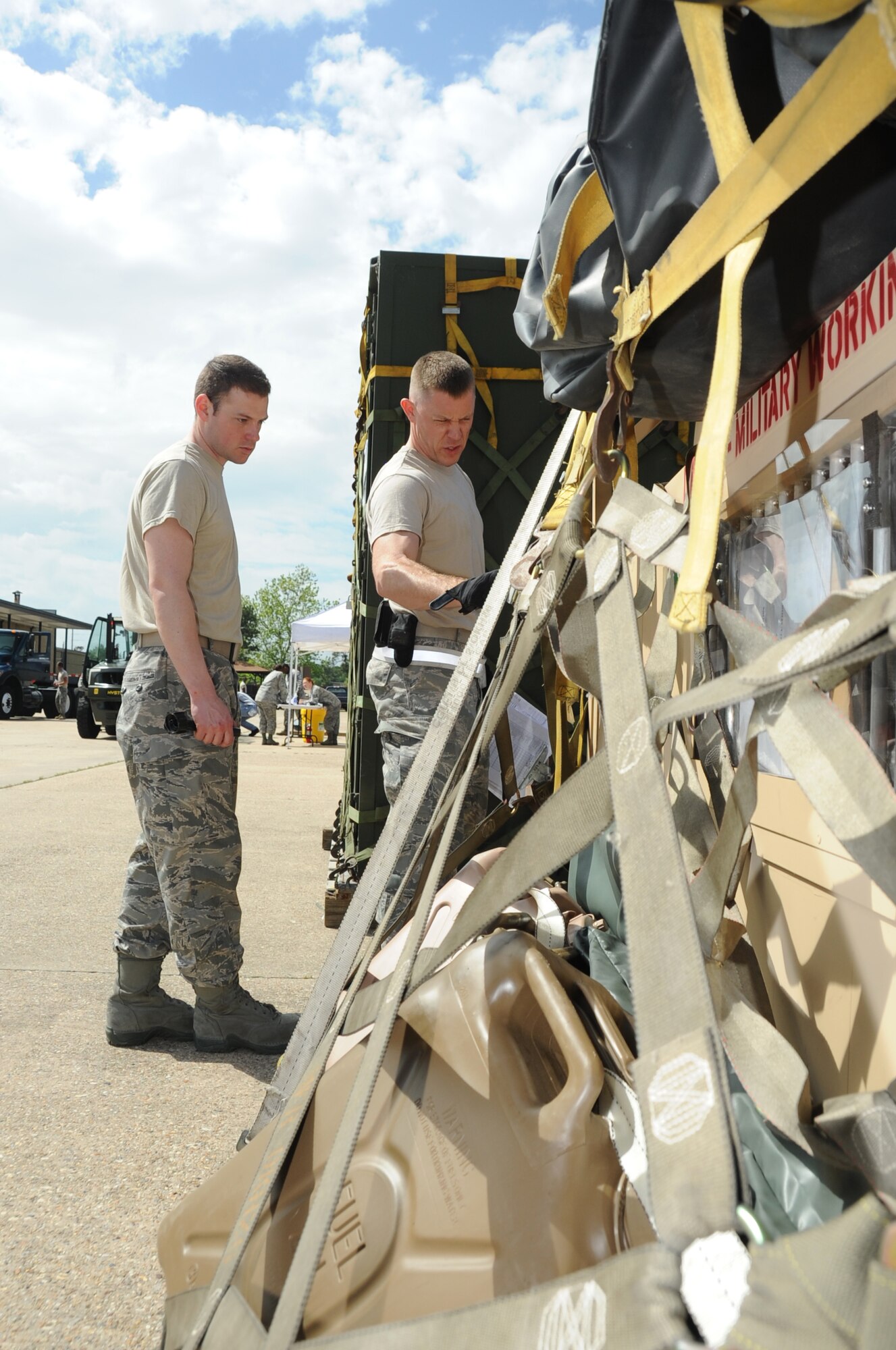 Staff Sgt. Chad Byall, 81st Security Forces Squadron, conducts a joint inspection with Staff Sgt. David Frahm, 81st Logistics Readiness Squadron, on Byall’s cargo during a deployment exercise March 29, 2012, outside the 81st Logistics Readiness Squadron warehouse at Keesler Air Force Base, Miss.  (U.S. Air Force photo by Kemberly Groue)